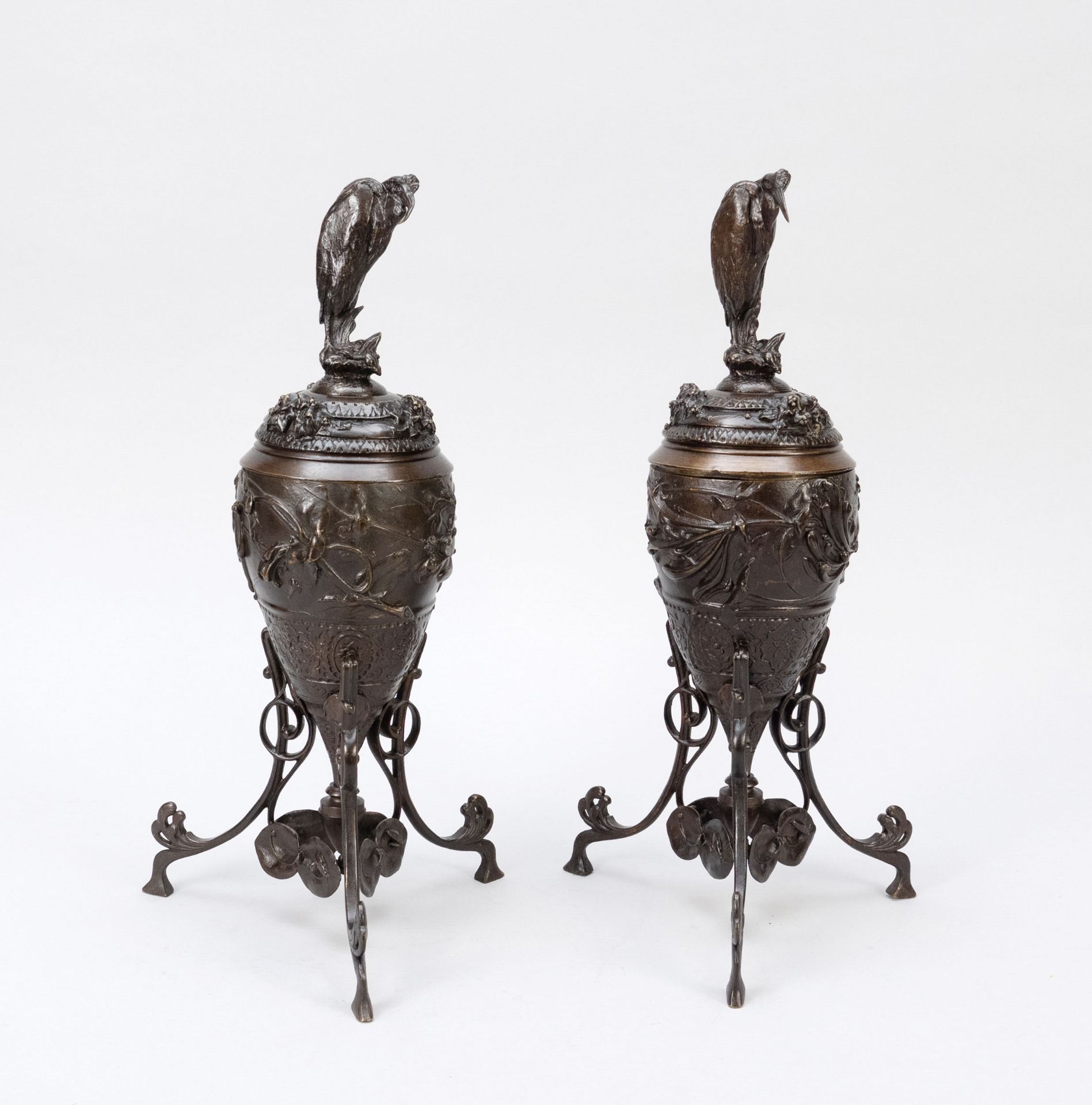 Pair of lidded vessels, 19th c., dark patinated bronze. Trefoil stand as stylized leaf tendril,