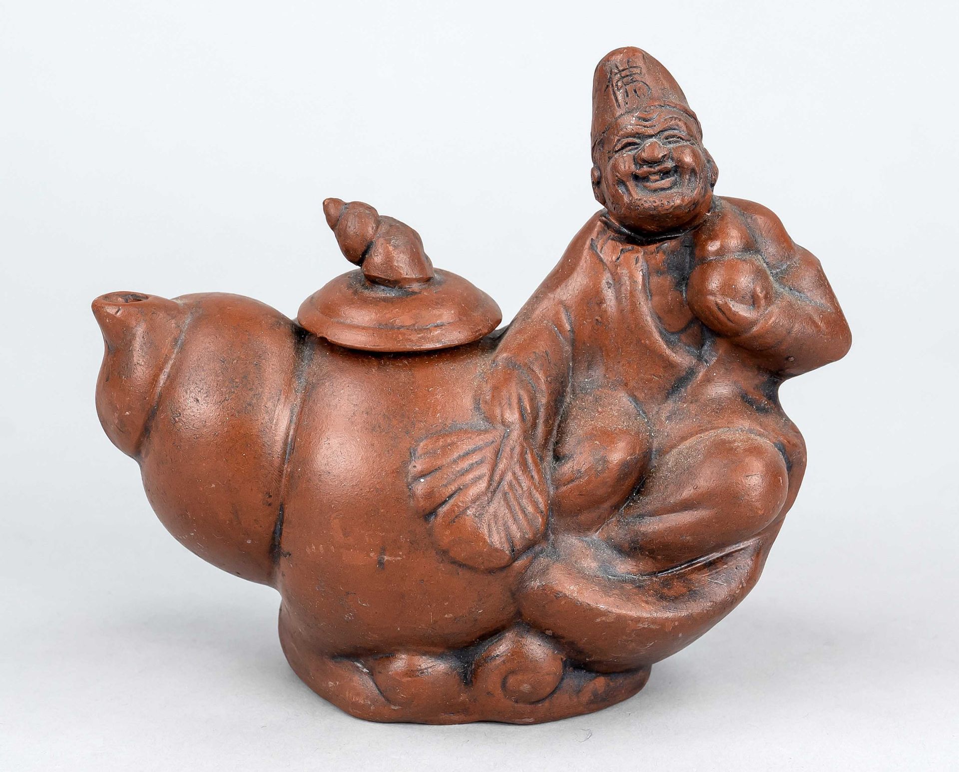 Yixing figure, China, 19th/20th century, reddish earthenware, a sage with gourd bottle is sitting on