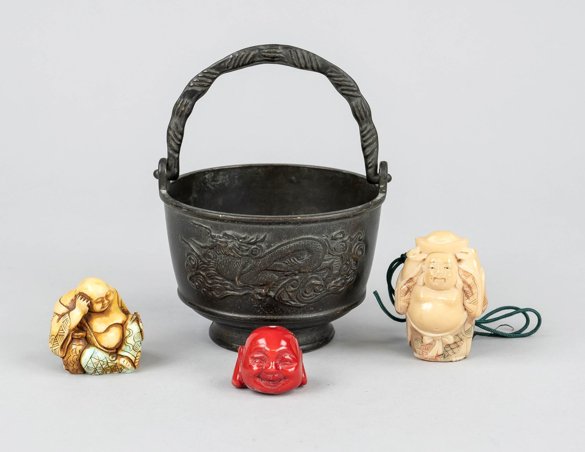 3 fat sack buddhas in handle pot, China, 20th c., metal cast dragon pot contains 2 netsuke budai and