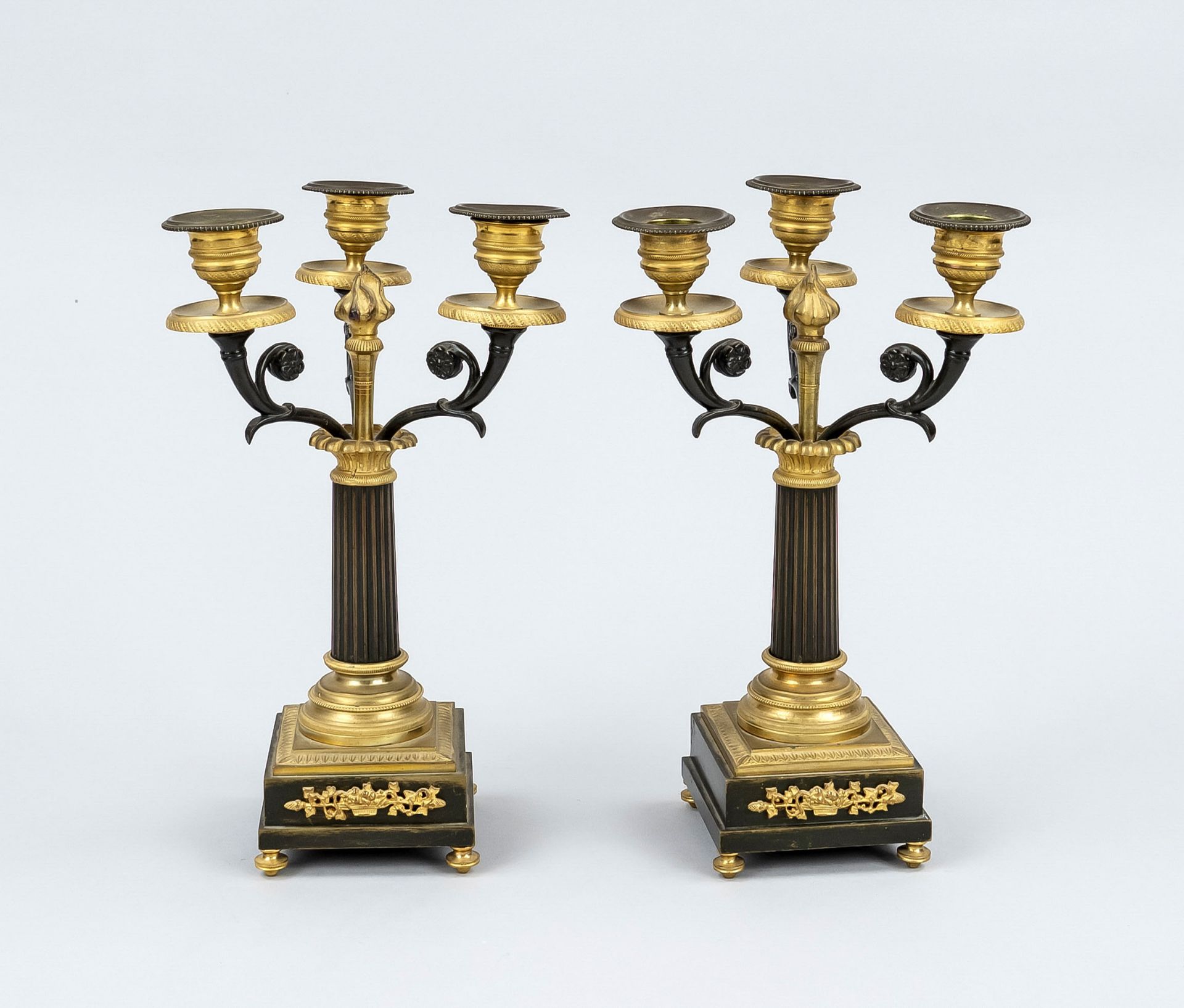 Pair of Empire style candlesticks, late 19th c., bronze, partially gilded. Square, profiled and