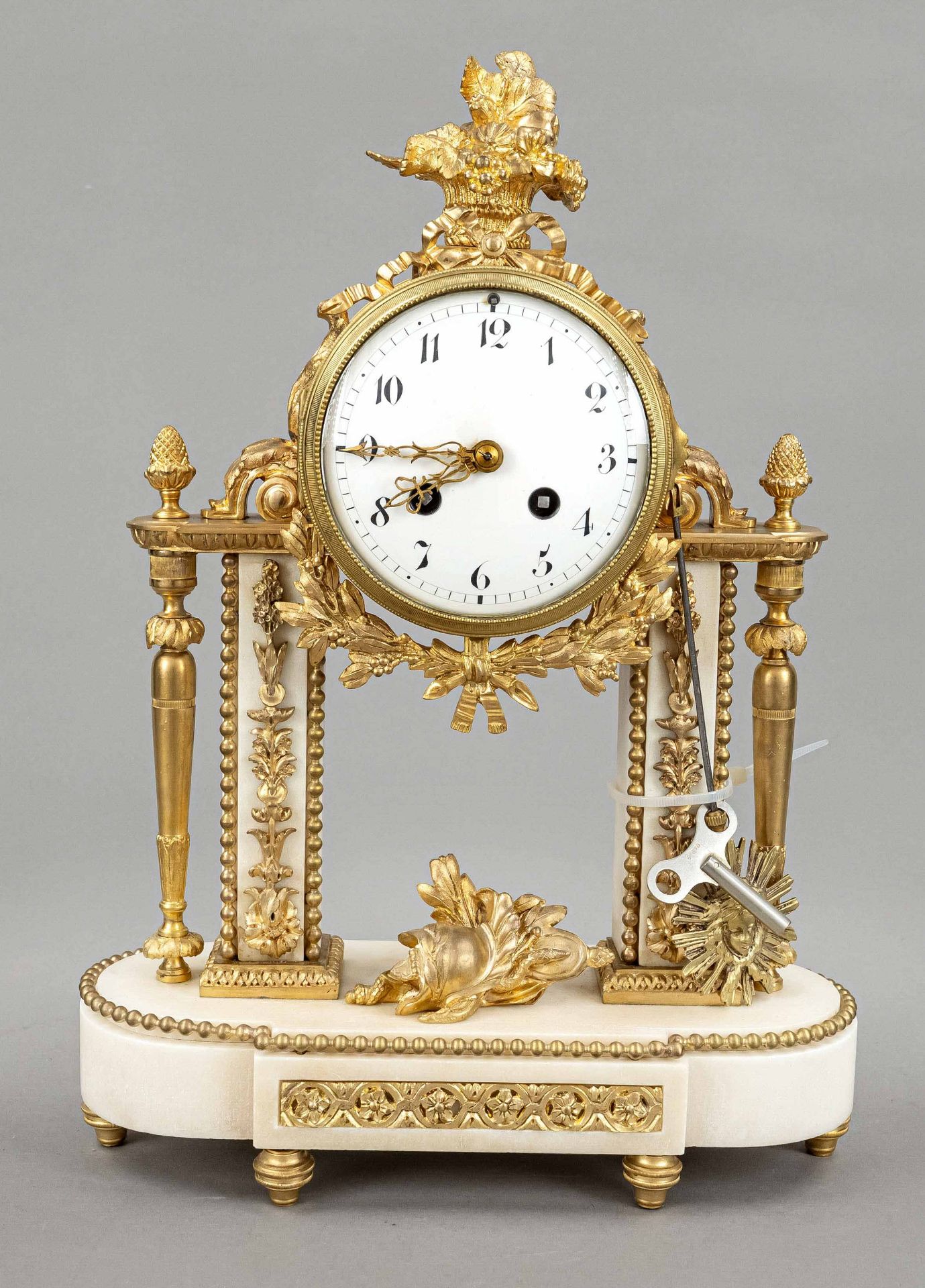 french. Pendule Louis Seize, 2nd half 19th century, color gilded, white marble base and columns,