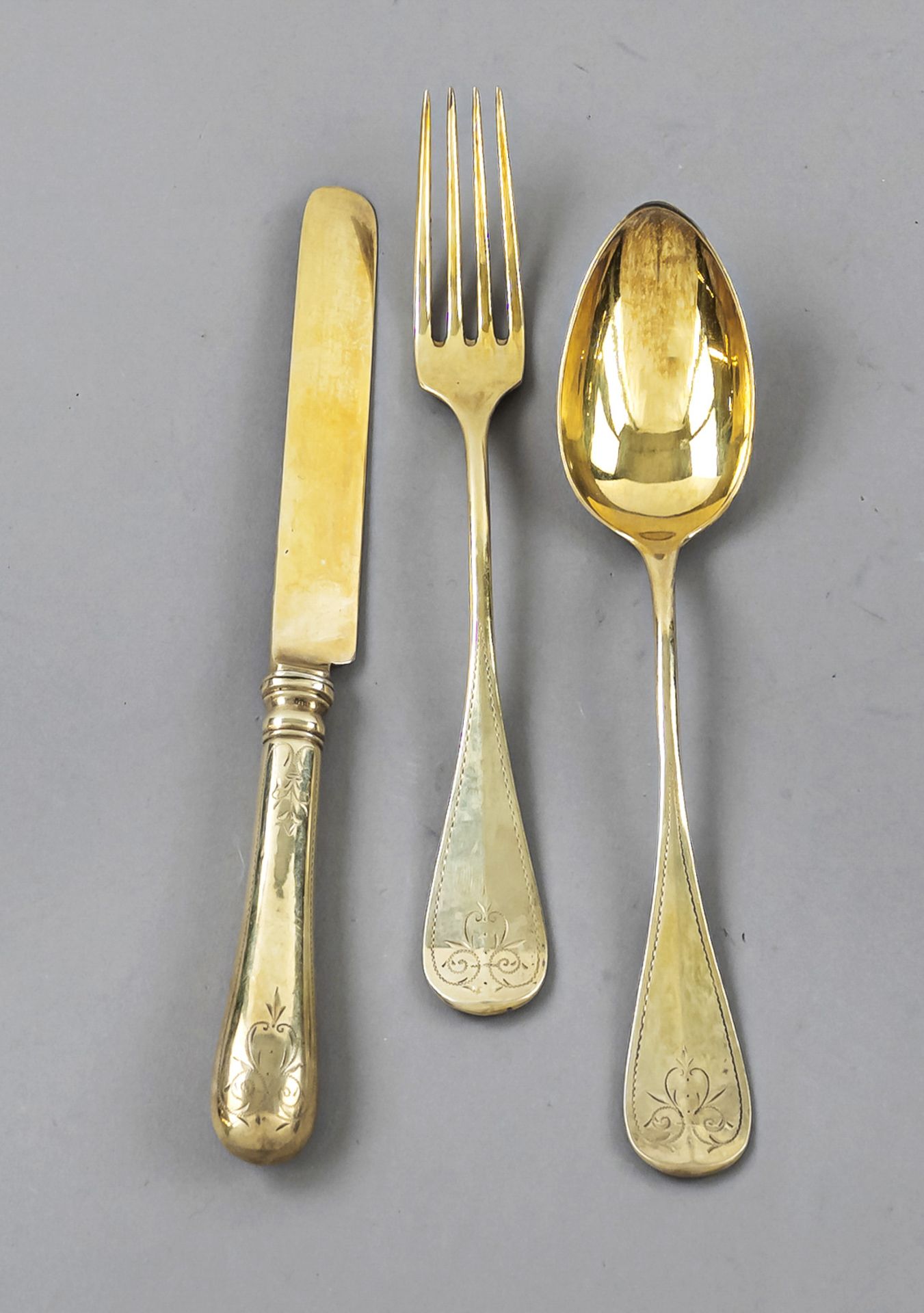 Dinner set, around 1900, silver 800/000, gilded, rounded handles with engraved decoration and