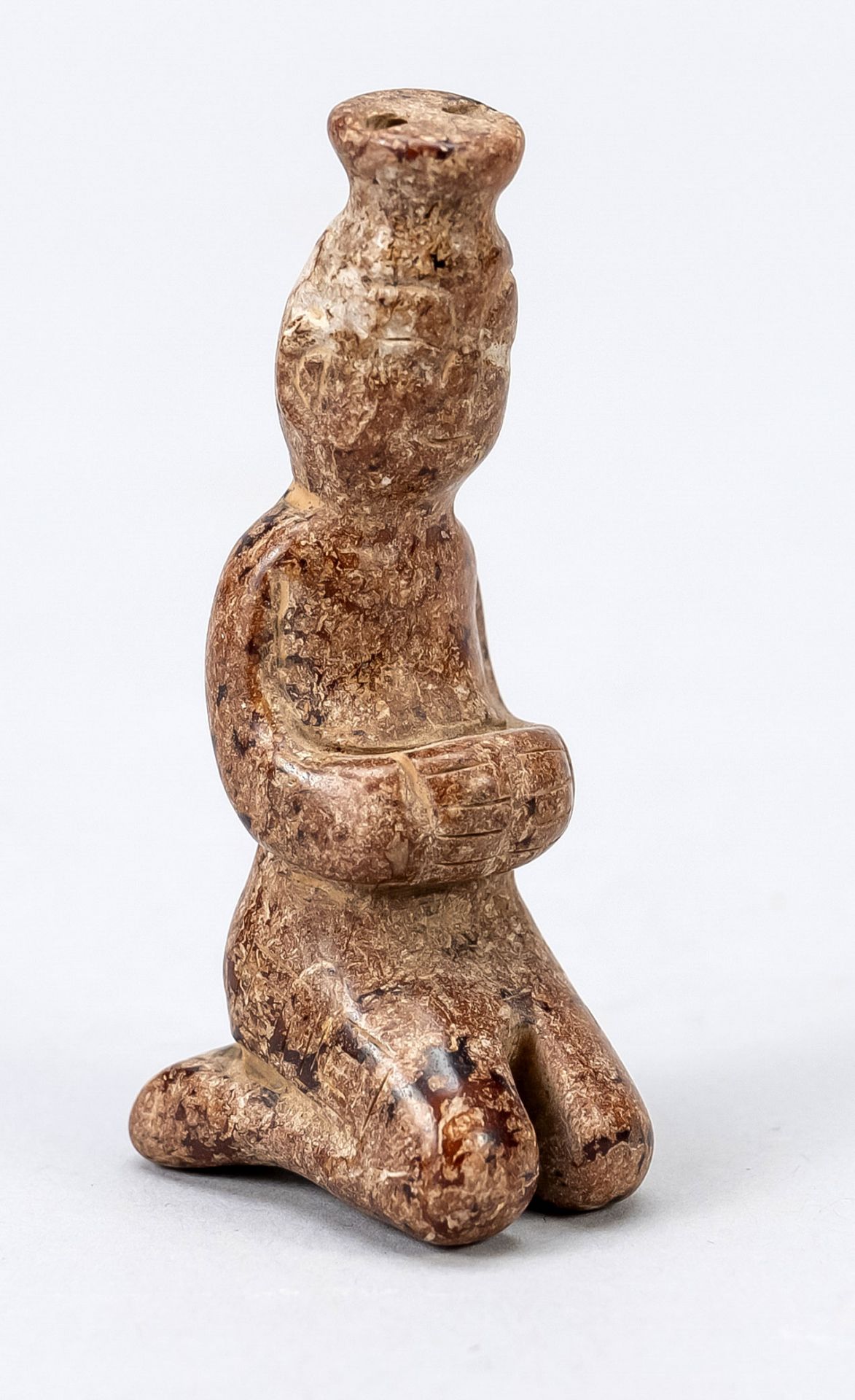 Figurine, probably Hongshan culture China, kneeling worshiper carved in red speckled mineral