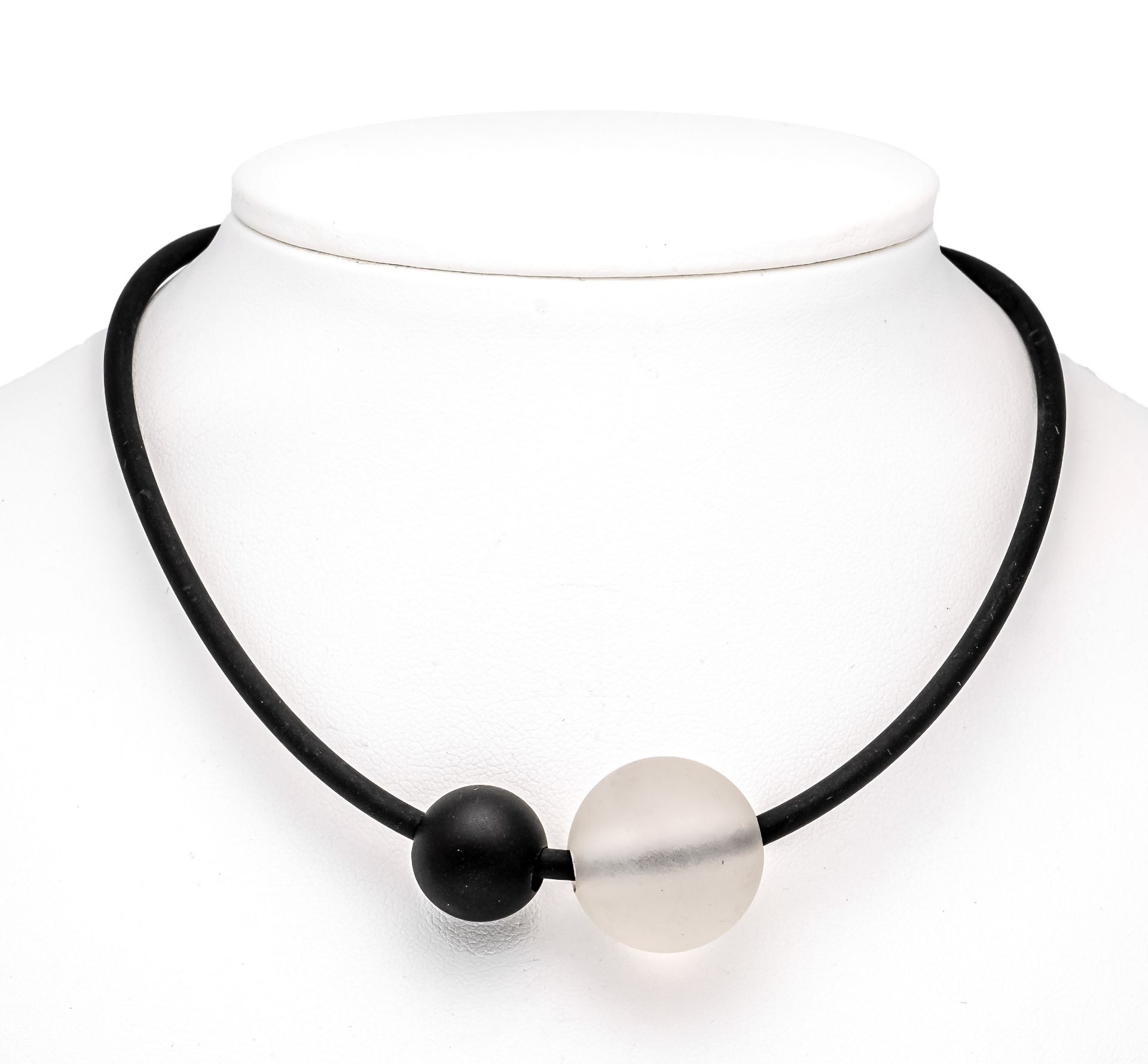 Design necklace with a matted rock crystal 20 mm and an onyx ball 14 mm as glider on black rubber