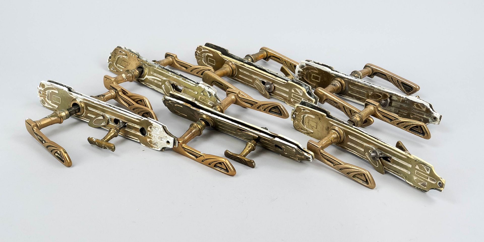 7 identical Art Nouveau lever handles and a box lock, circa 1900, brass. Matching curved trim with