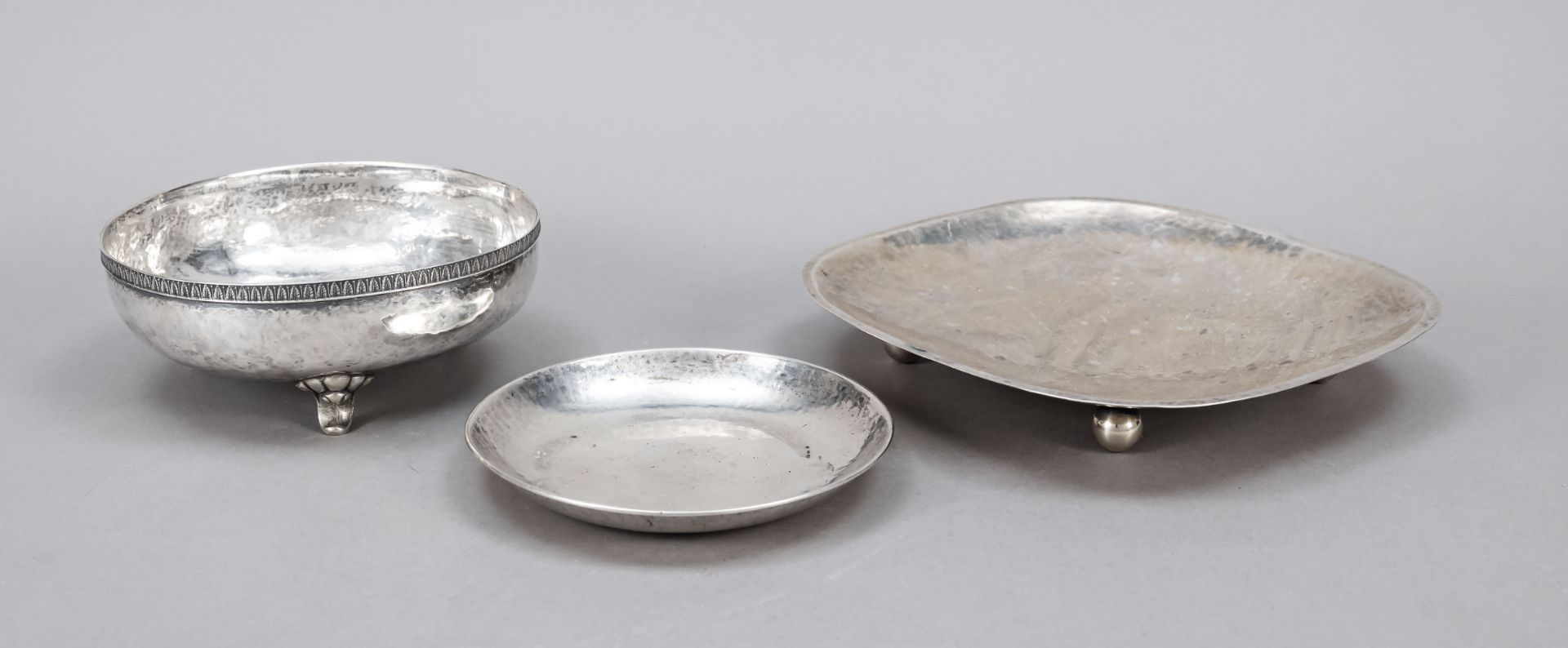 Three bowls, 20th century, different makers, silver of different finenesses, each with hammered