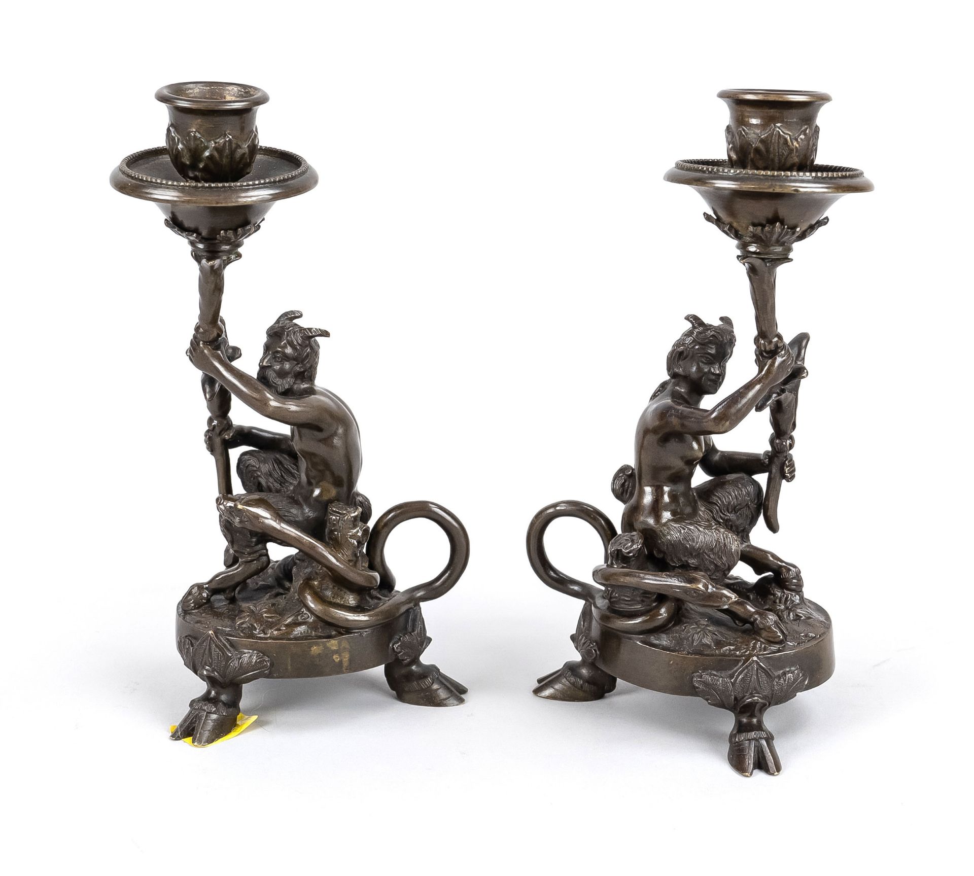 pair of candlesticks with faun & faunin, 19th/20th c., bronze, dark patinated. Each sitting on a