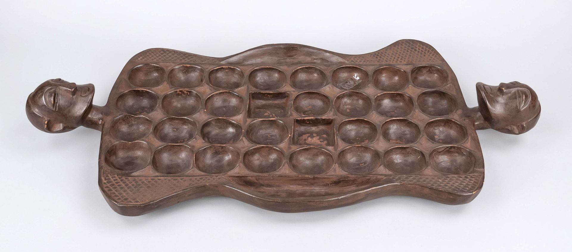 African board game, probably 20th c., dark hardwood, figural carving on the narrow sides, 83 x 39
