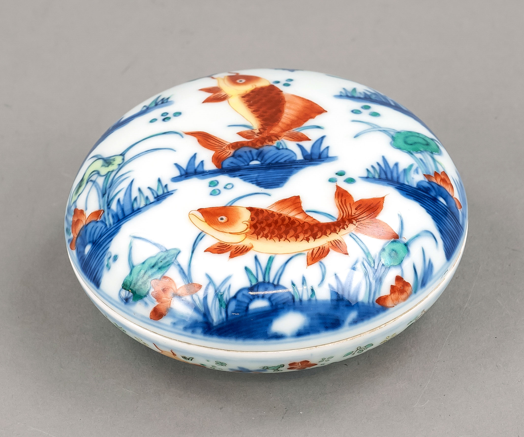 Wucai lidded box, China, 20th c., porcelain with carp and other fish executed in wucai technique,