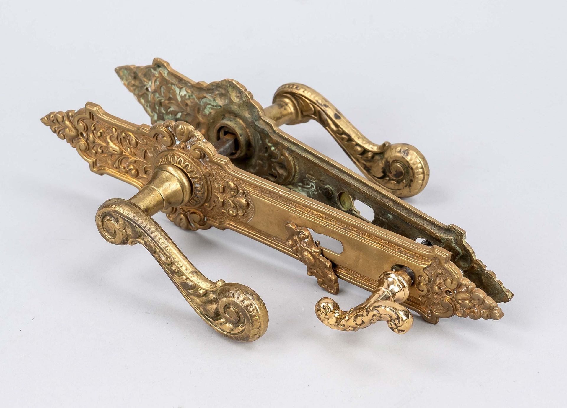Handle set, end of the 19th century, brass. Curved ornamented handle with a curved ornamental