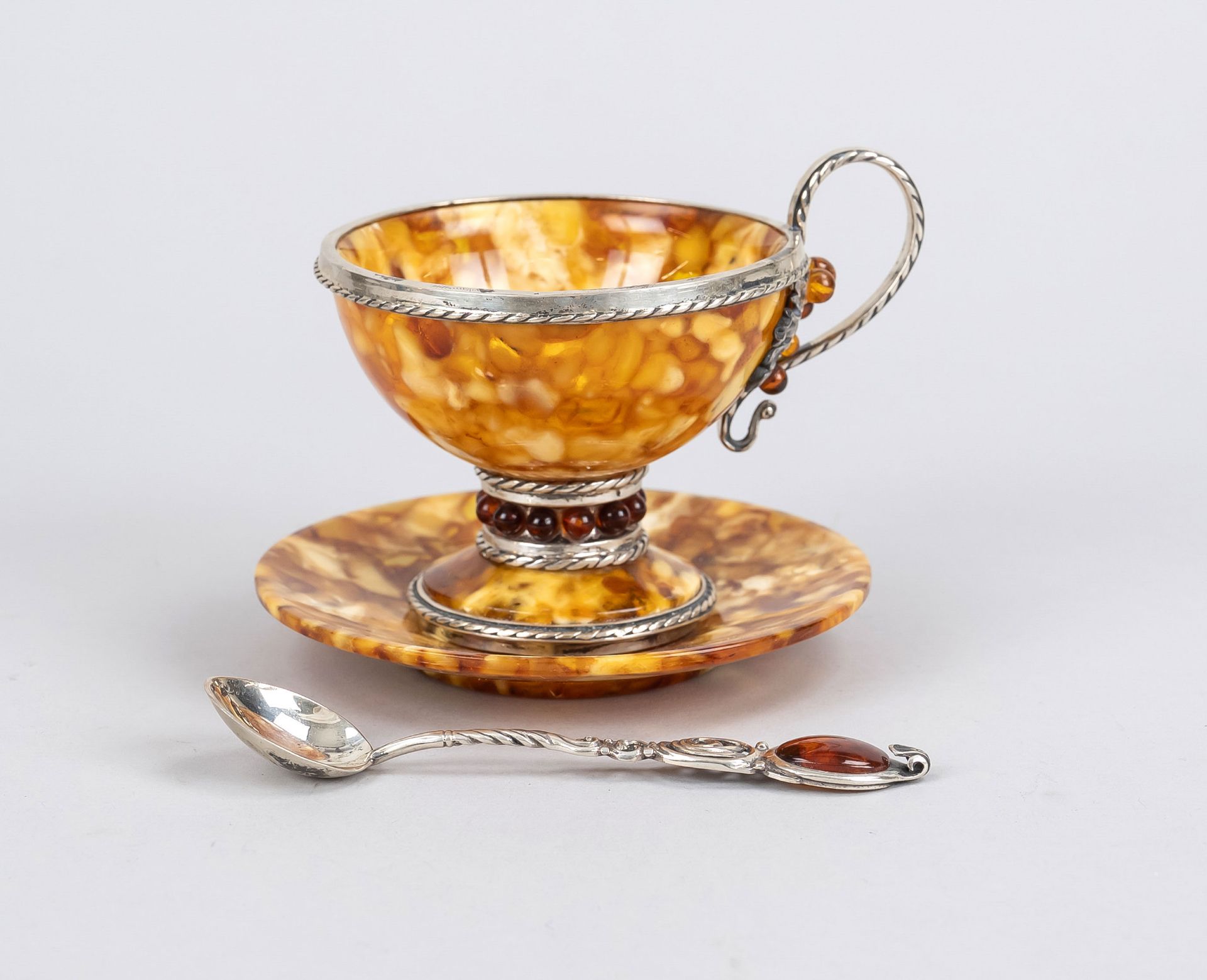 Cup with saucer and spoon, 20th c., amber with silver plated mount, slightly ber, h. 9 cm