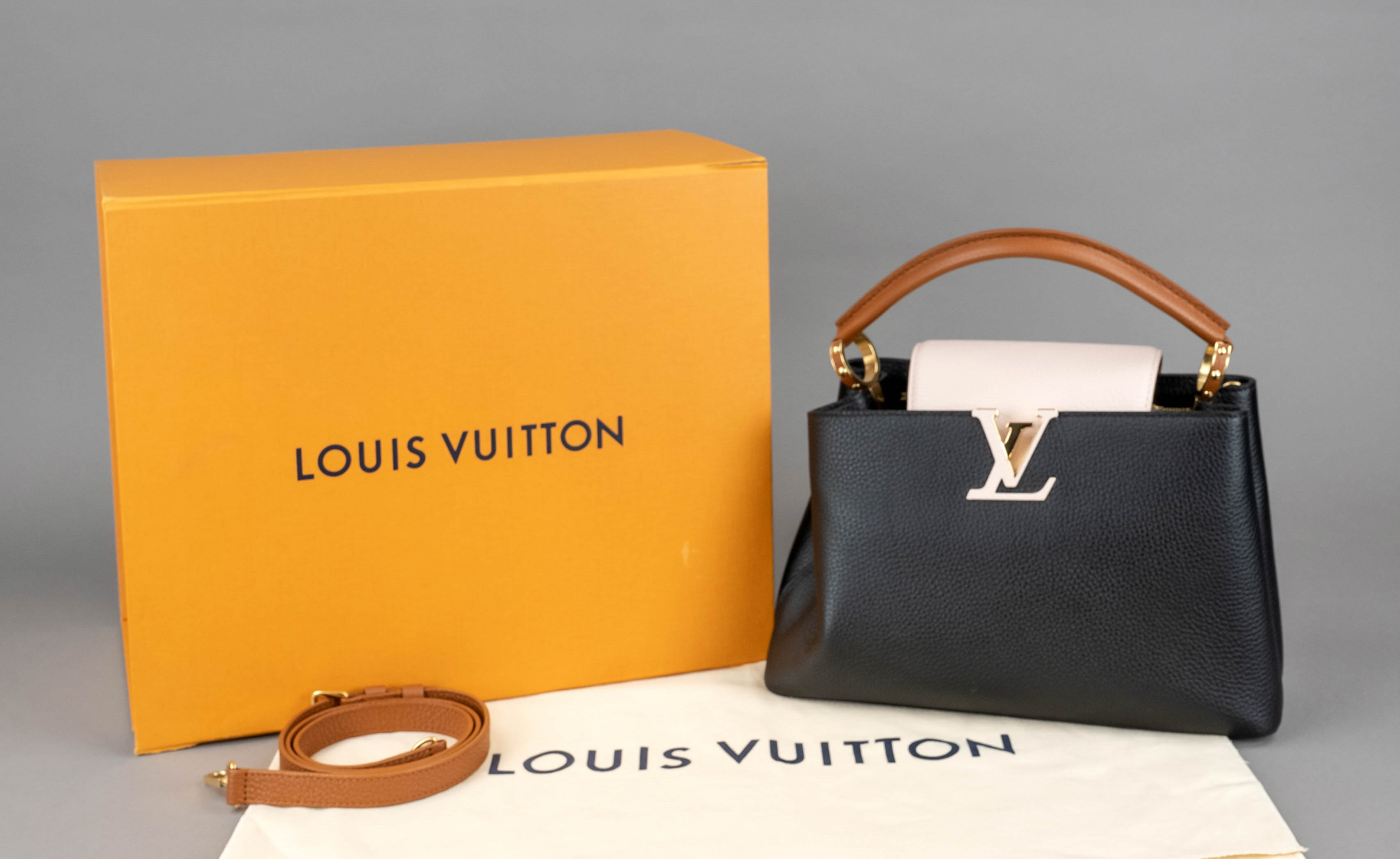 Louis Vuitton, Capucines PM, black, powder and cognac grained taurillon leather, gold-tone hardware,