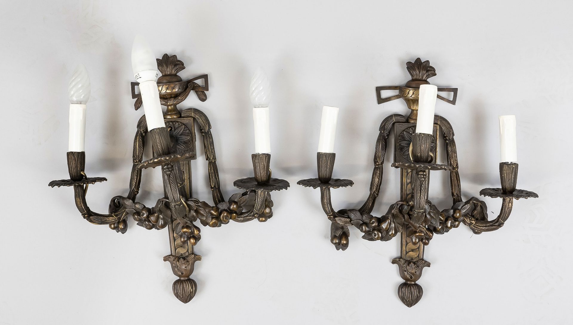 Pair of wall lamps, 20th c., bronze/brass. Ornamented wall part with vase top, 3 curved