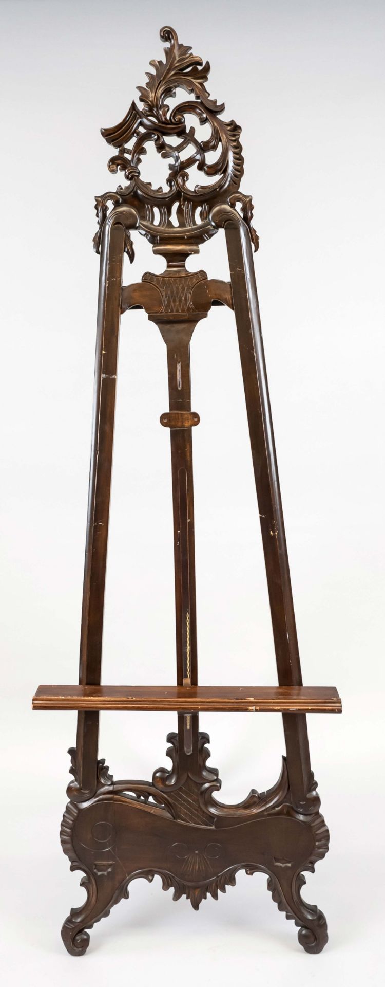 Easel, mid 20th century, mahogany? Openwork and carved. Height-adjustable picture rest, fold-out