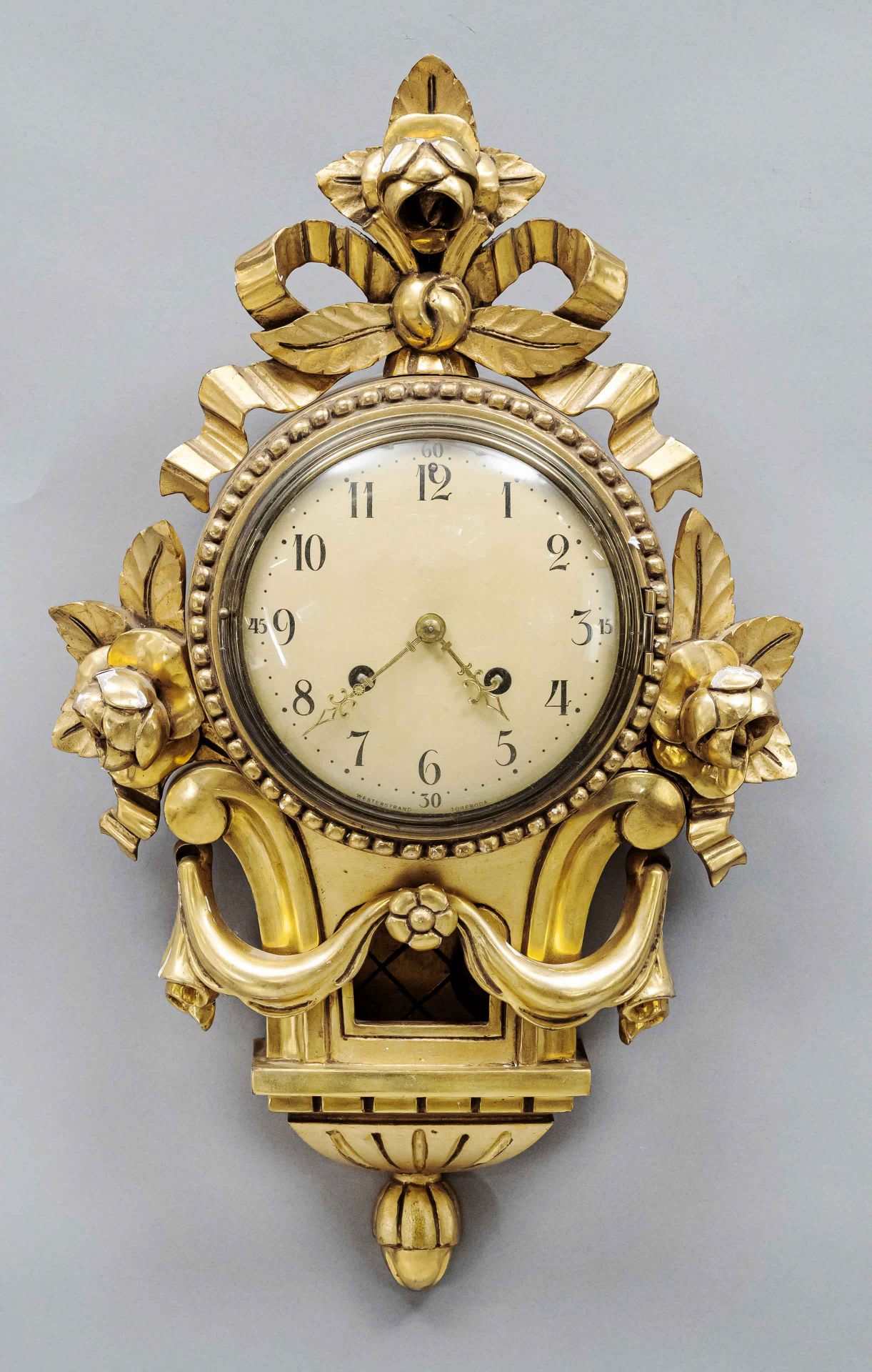 Cartell clock wood leaf gilded, 2nd half 20th century, with bows and rose decorations, gold dial