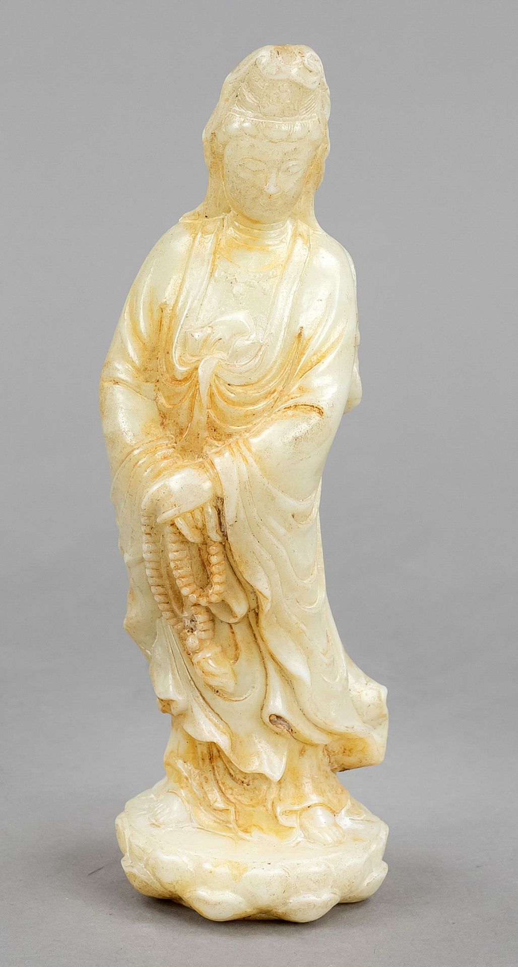 Guanyin with rosary, China, 20th century, whitish jade-like mineral carved, merciful Avalokiteshvara