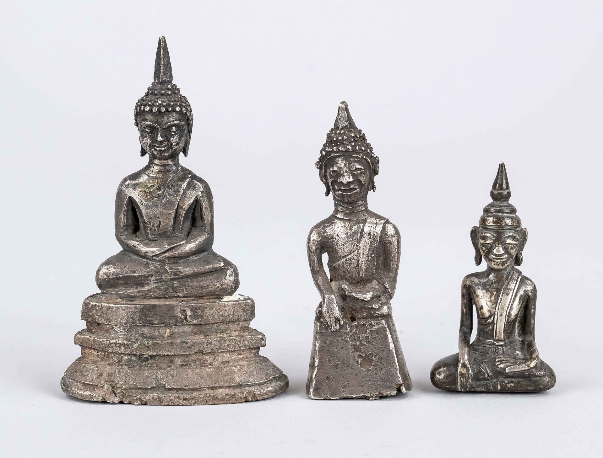 3 Buddhas, Thailand, 19th/20th c., 3x Buddha Shakyamuni, partly sworded, silver tested, h to 10,5cm,