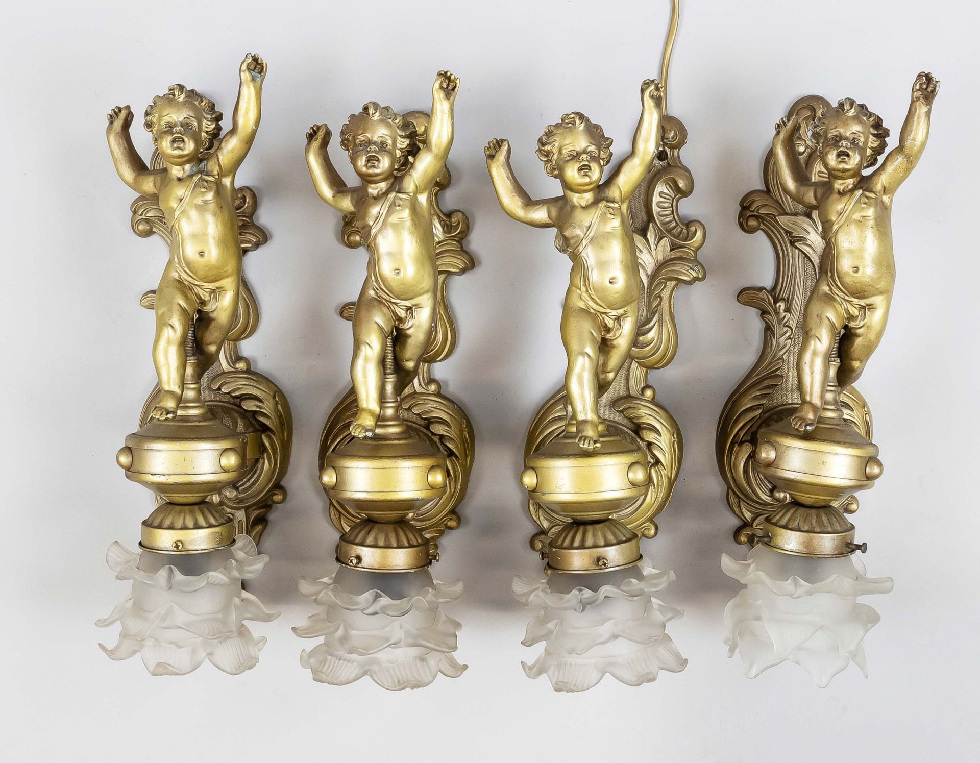 4 wall lamps with putti, 20th c. Ornamented and bronzed wall part, putto standing on console,