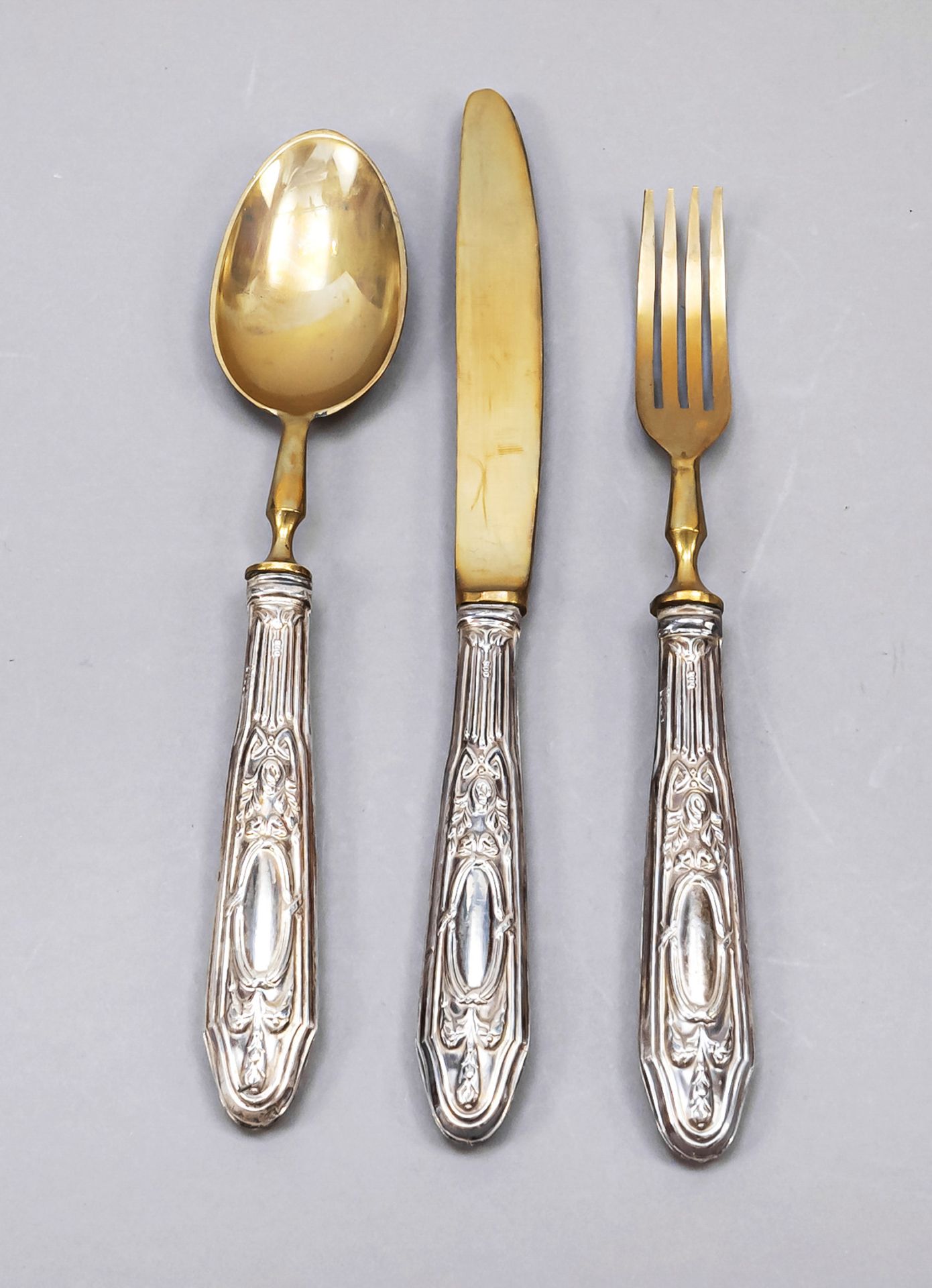 Three pieces children's cutlery, around 1900, silver 800/000, filled handles with floral and