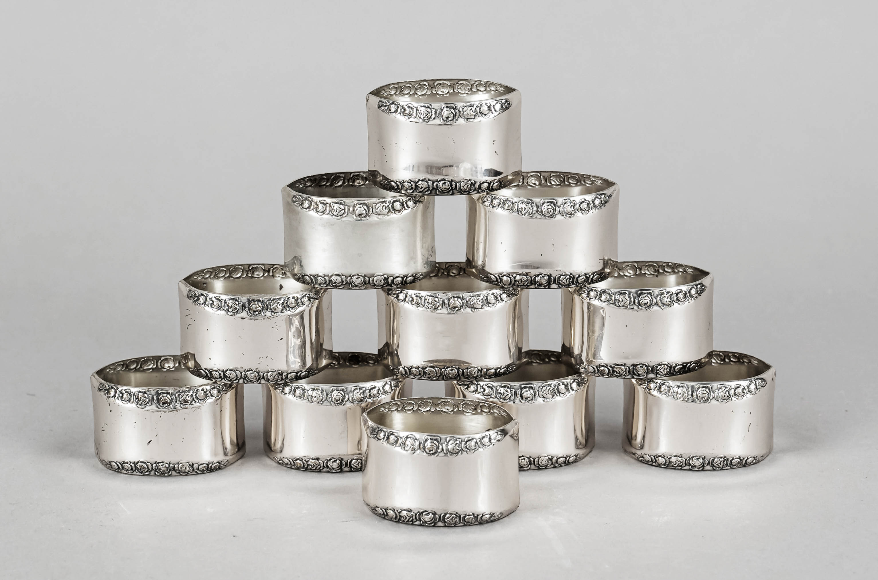 Eleven napkin rings, 20th century, marked Antiko, silver 800/000, oval shape, with relief