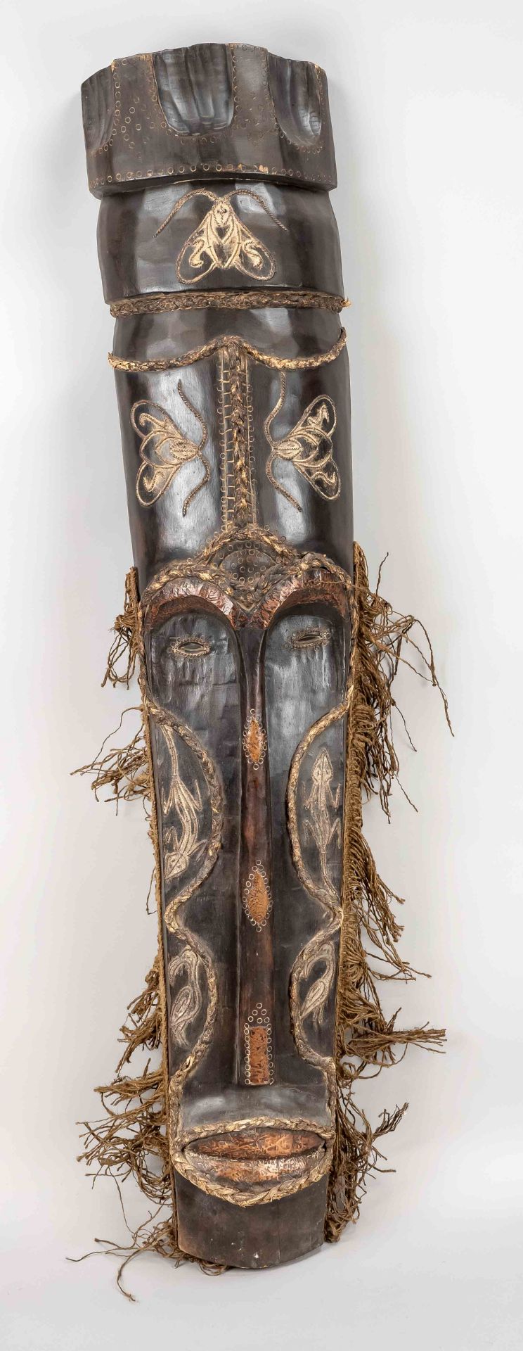 Large dancing mask, probably West Africa, 20th century, dark hardwood with copper and textile