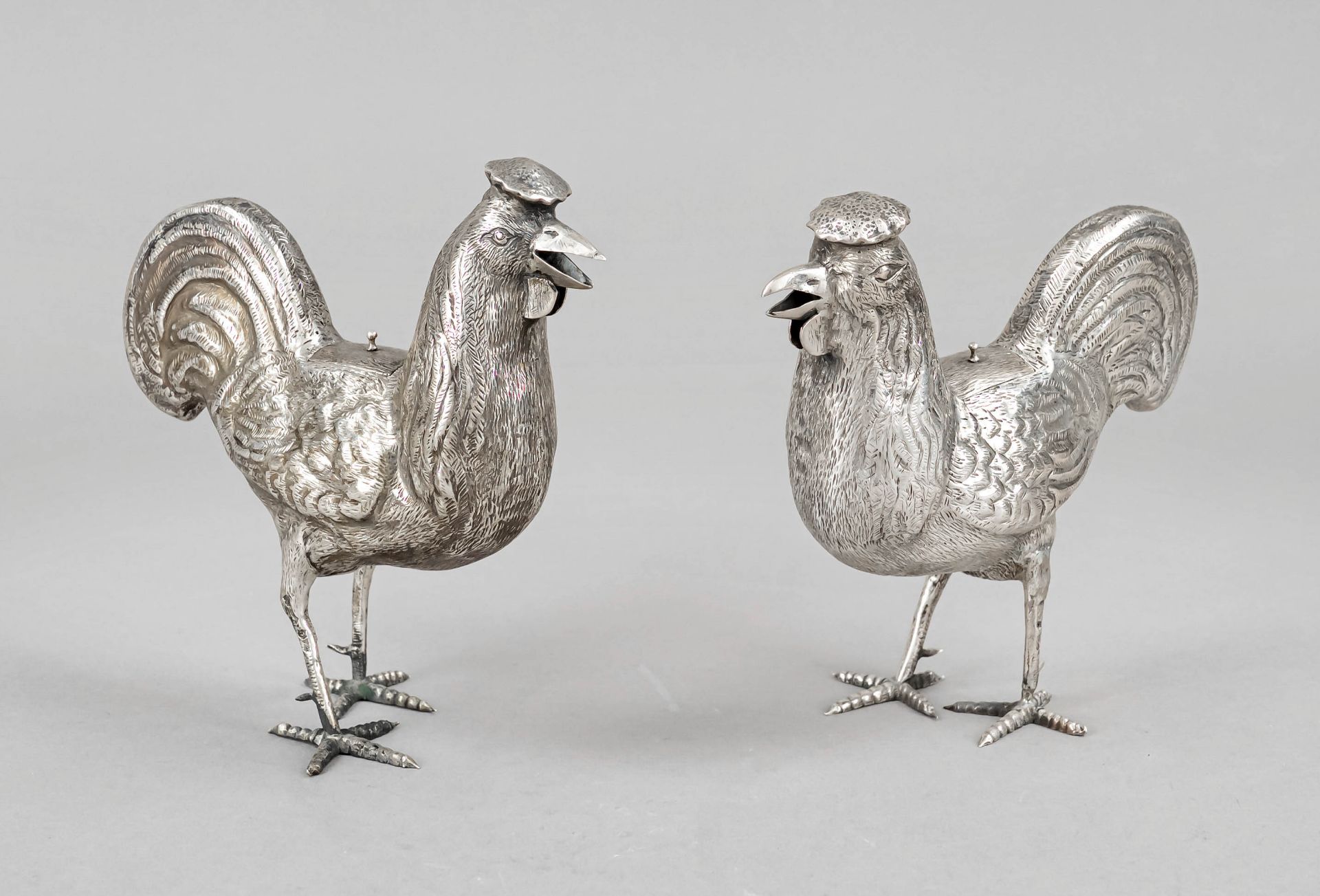 Pair of figural lidded boxes, 20th c., silver tested, in the shape of standing chickens, h. 14 cm,