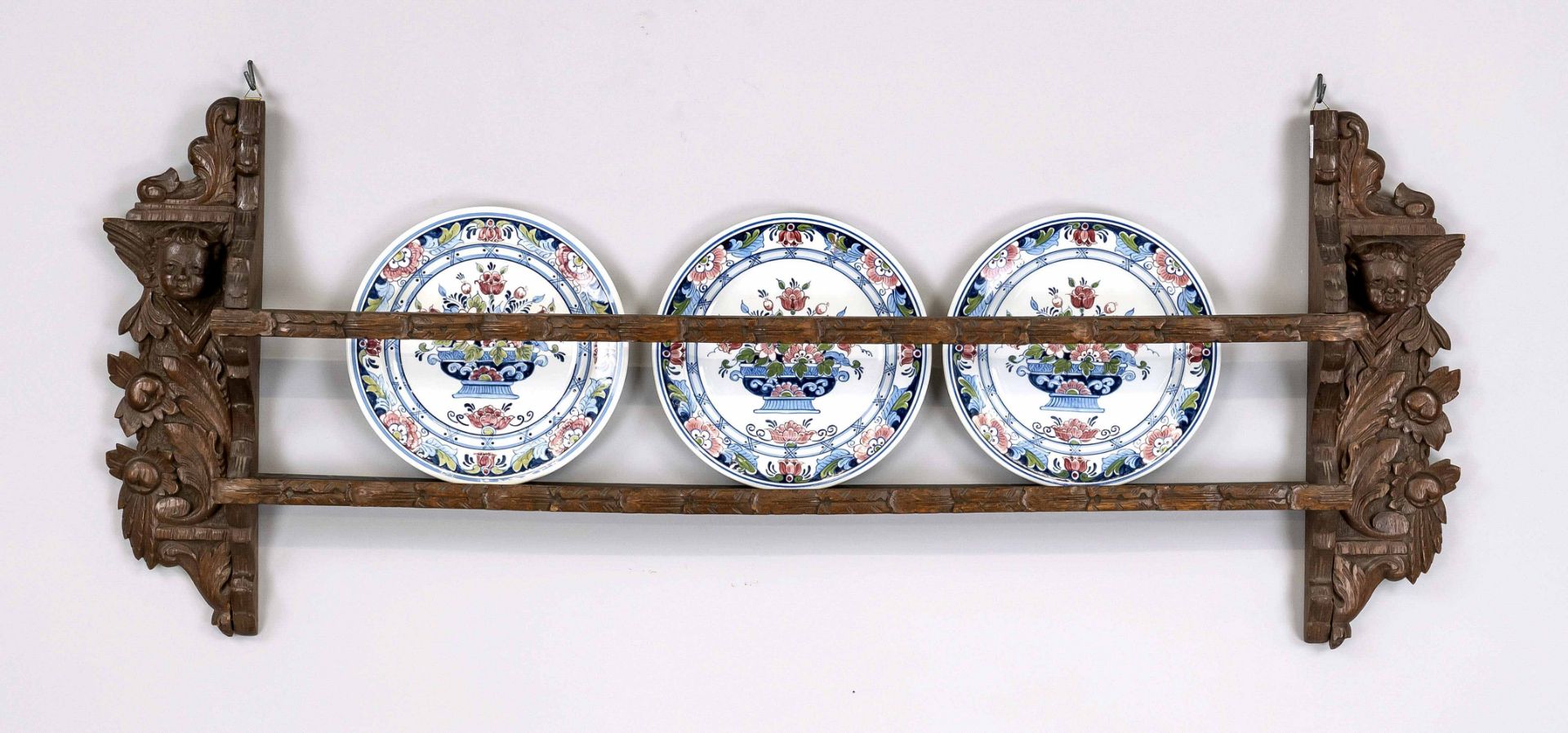 Plate shelf with 3 plates, Holland, 19th/20th c. Delft plate with polychrome floral decor. Carved