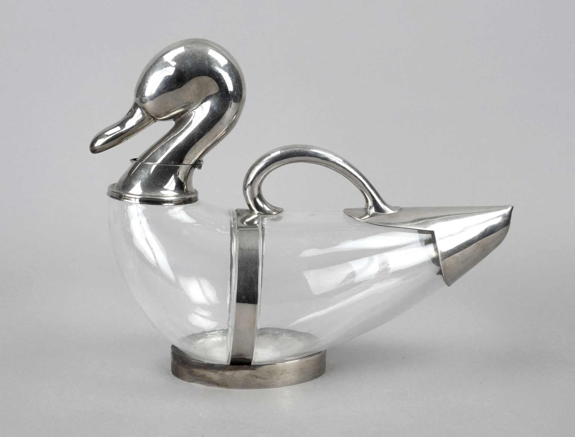 Figural carafe with mounting, 20th c., plated, in the shape of a duck, body clear glass, l. 34,5 cm
