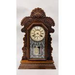 AN OAK CASED ANSONIA GINGERBREAD CLOCK.