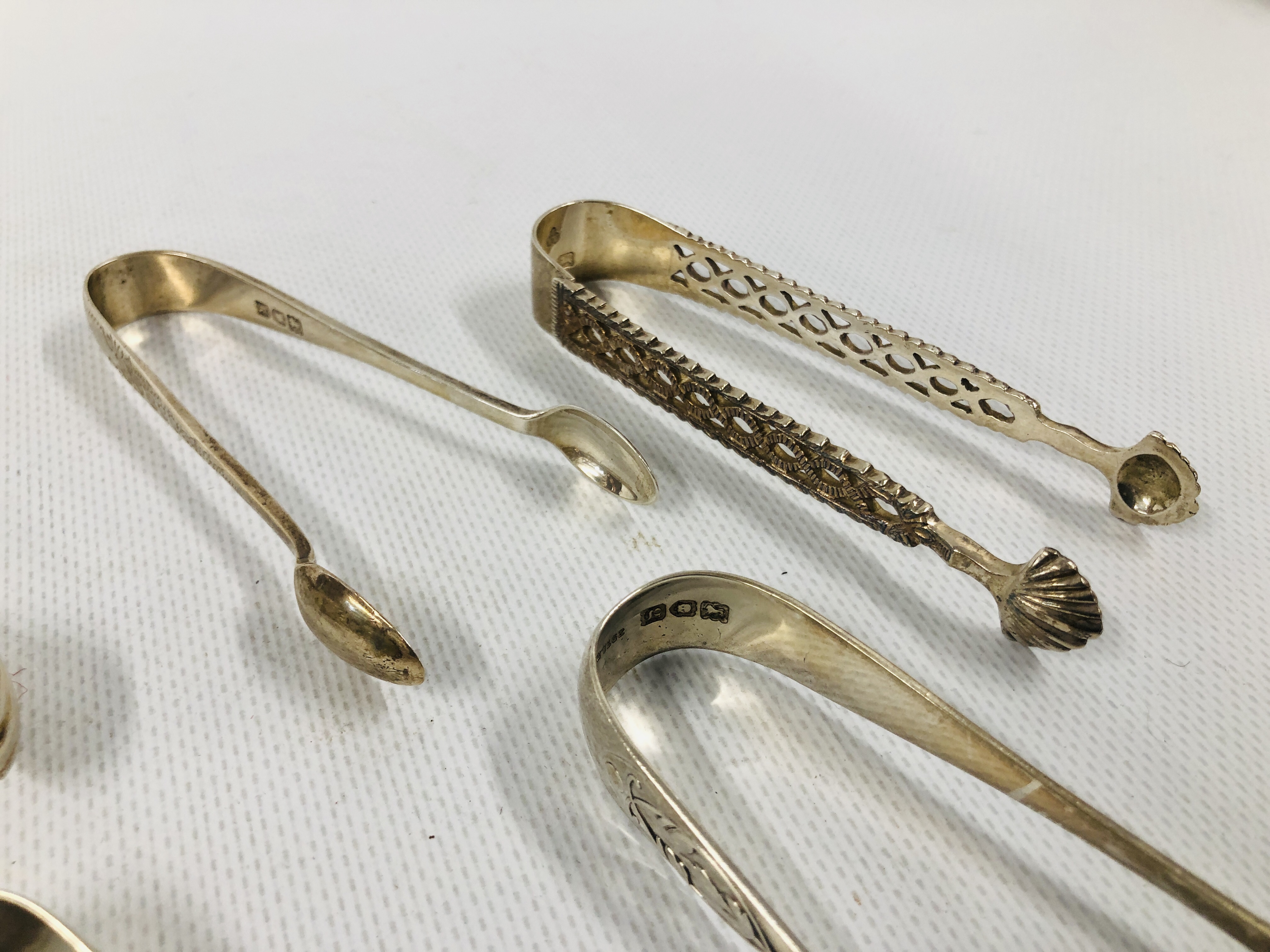 GROUP OF 8 VARIOUS SILVER SUGAR NIPS INCLUDING A PIERCED EXAMPLE, VARIOUS MAKERS AND ASSAYS. - Image 4 of 6