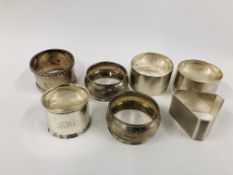 A GROUP OF SEVEN SILVER SERVIETTE RINGS VARIOUS MAKERS AND ASSAYS