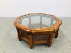 A GLASS TOP OCTAGONAL COFFEE TABLE WITH LOWER BERGERE WORK SHELF