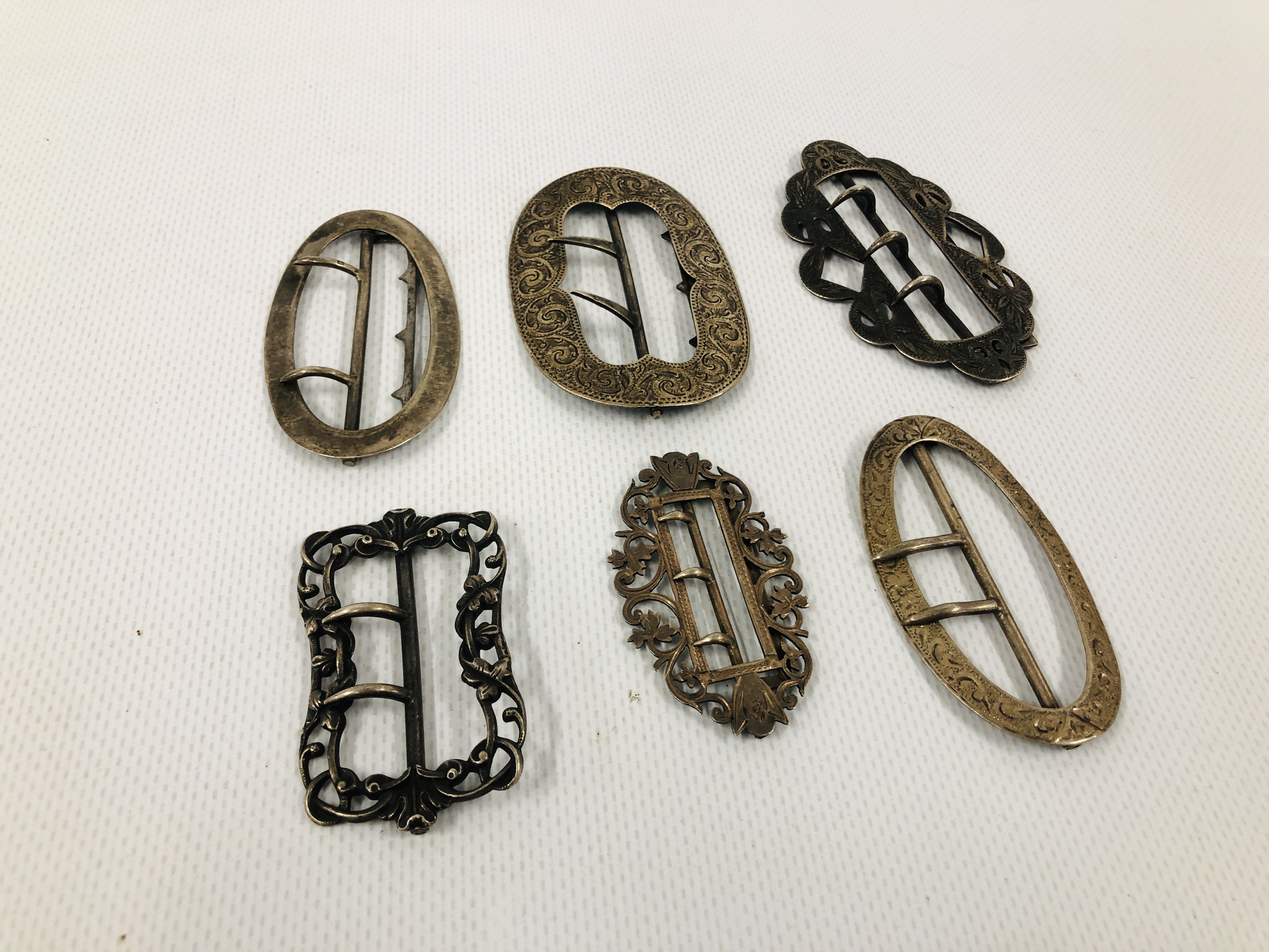 A GROUP OF SIX VARIOUS SILVER BUCKLES INCLUDING AN EXAMPLE BY ADIE & LOVEKIN, BIRMINGHAM ASSAY.