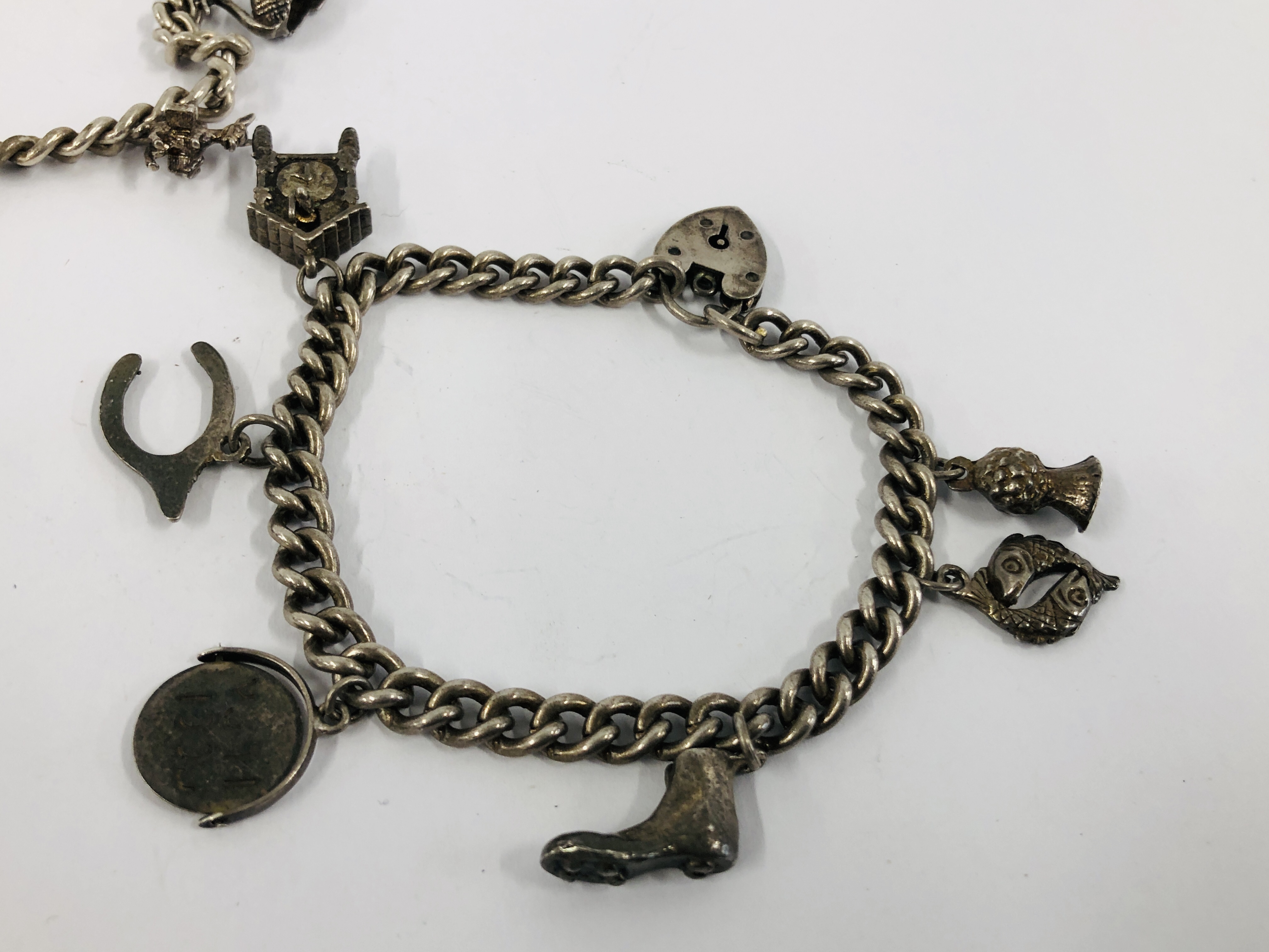 THREE VINTAGE SILVER CHARM BRACELETS TO INCLUDE VARIOUS SILVER AND WHITE METAL CHARMS. - Image 2 of 6