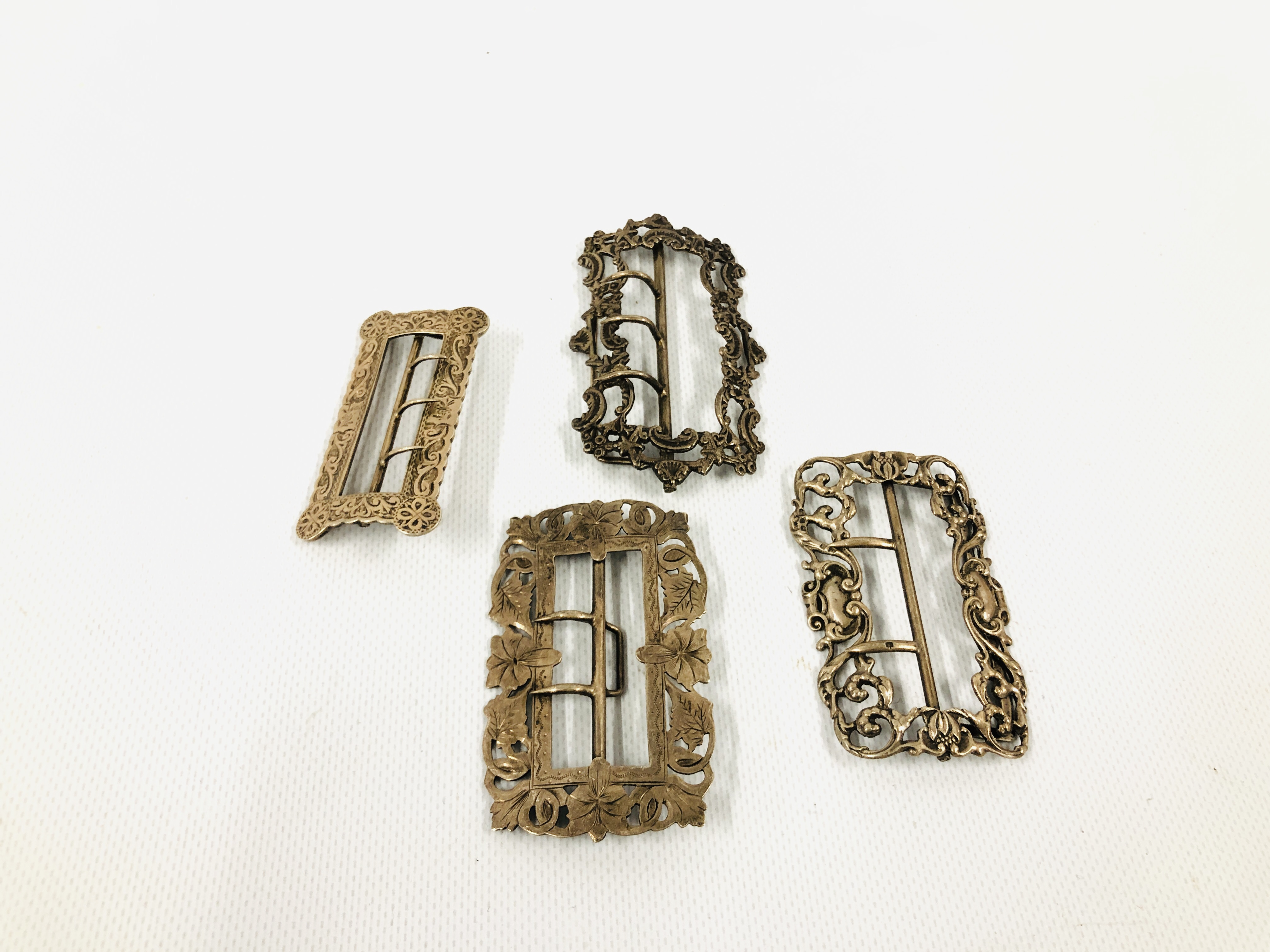 A GROUP OF FOUR SILVER BUCKLES OF SHAPED RECTANGULAR FORM INCLUDING ONE BY R&W BIRMINGHAM.