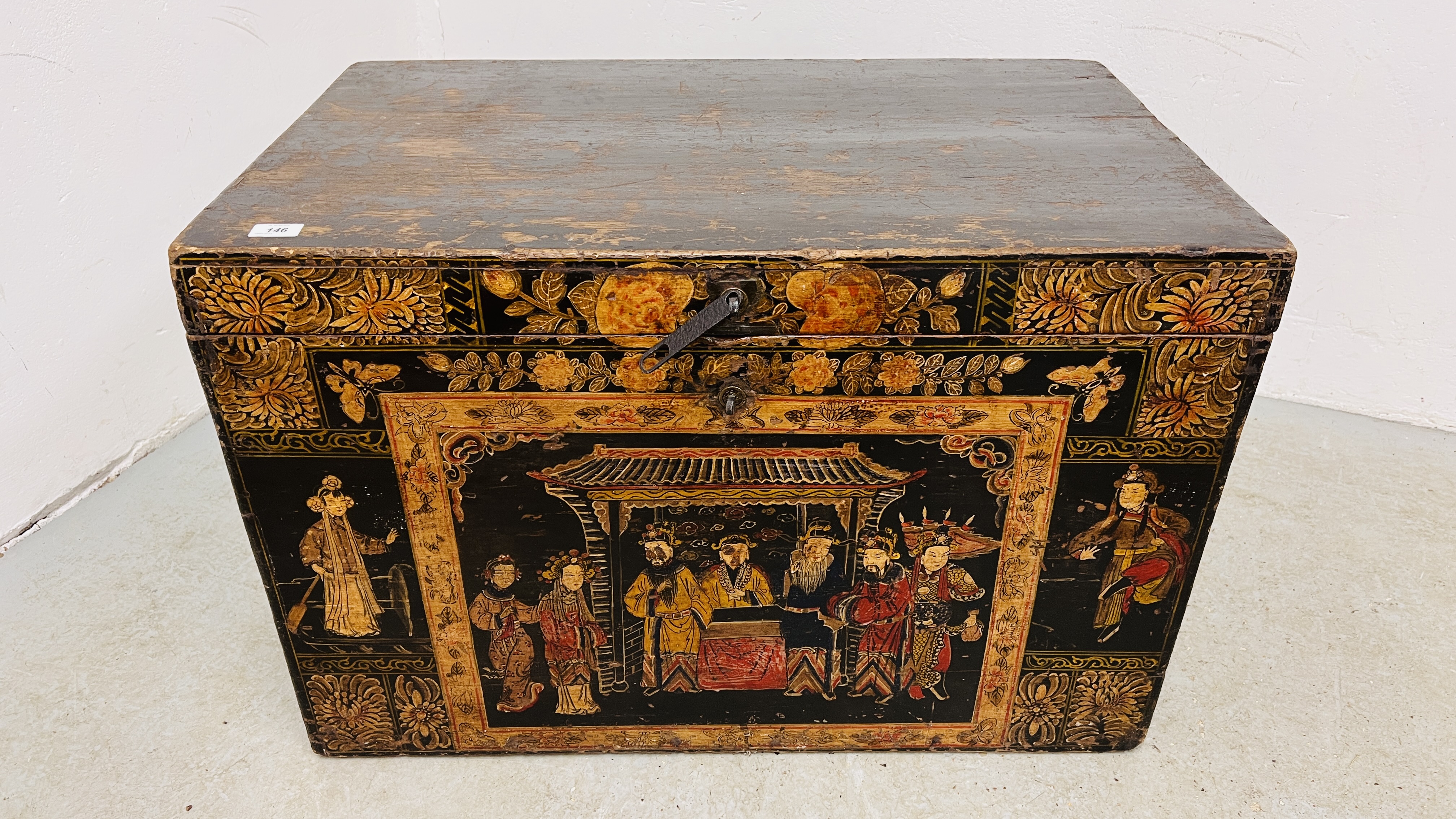 AN ANTIQUE JAPANESE CAMPHOR WOOD THEATRICAL COSTUME TRUNK THE FRONT PANEL DECORATED WITH FIGURES
