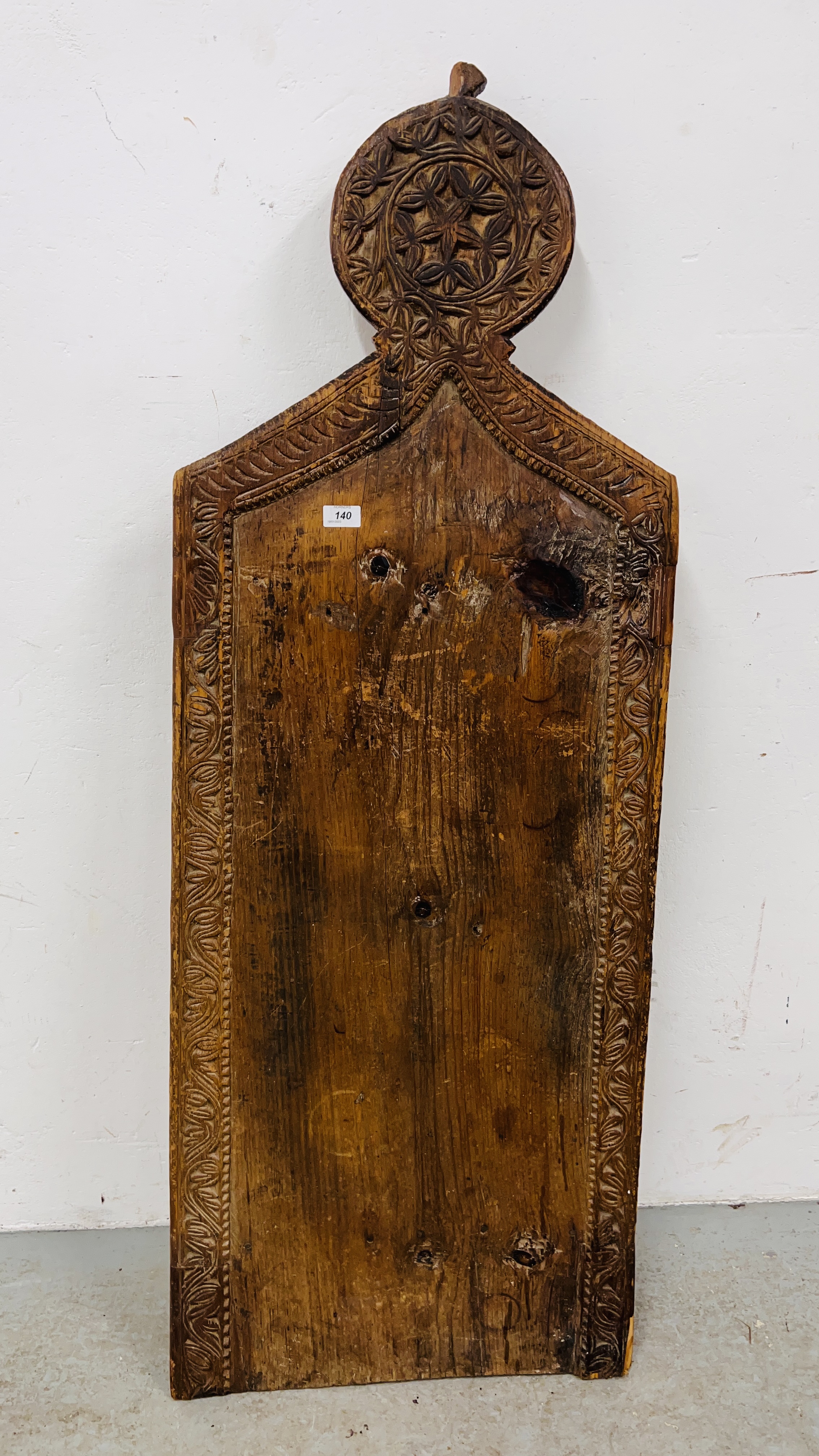 AN ANTIQUE PINE ISLAMIC PRAYER BOARD WITH CARVED DETAIL LENGTH 146CM. WIDTH 52CM.