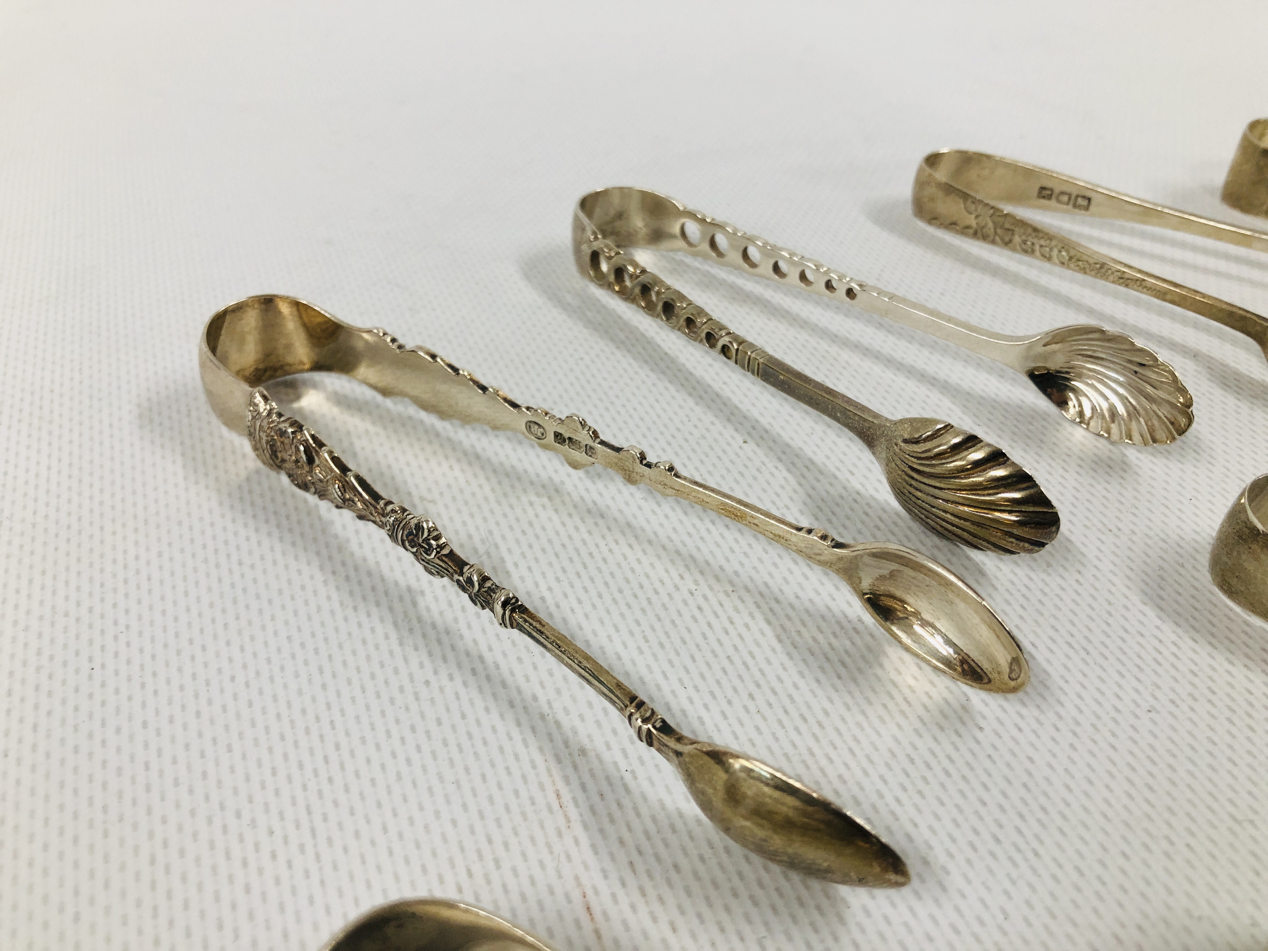 GROUP OF 8 VARIOUS SILVER SUGAR NIPS INCLUDING A PIERCED EXAMPLE, VARIOUS MAKERS AND ASSAYS. - Image 3 of 6