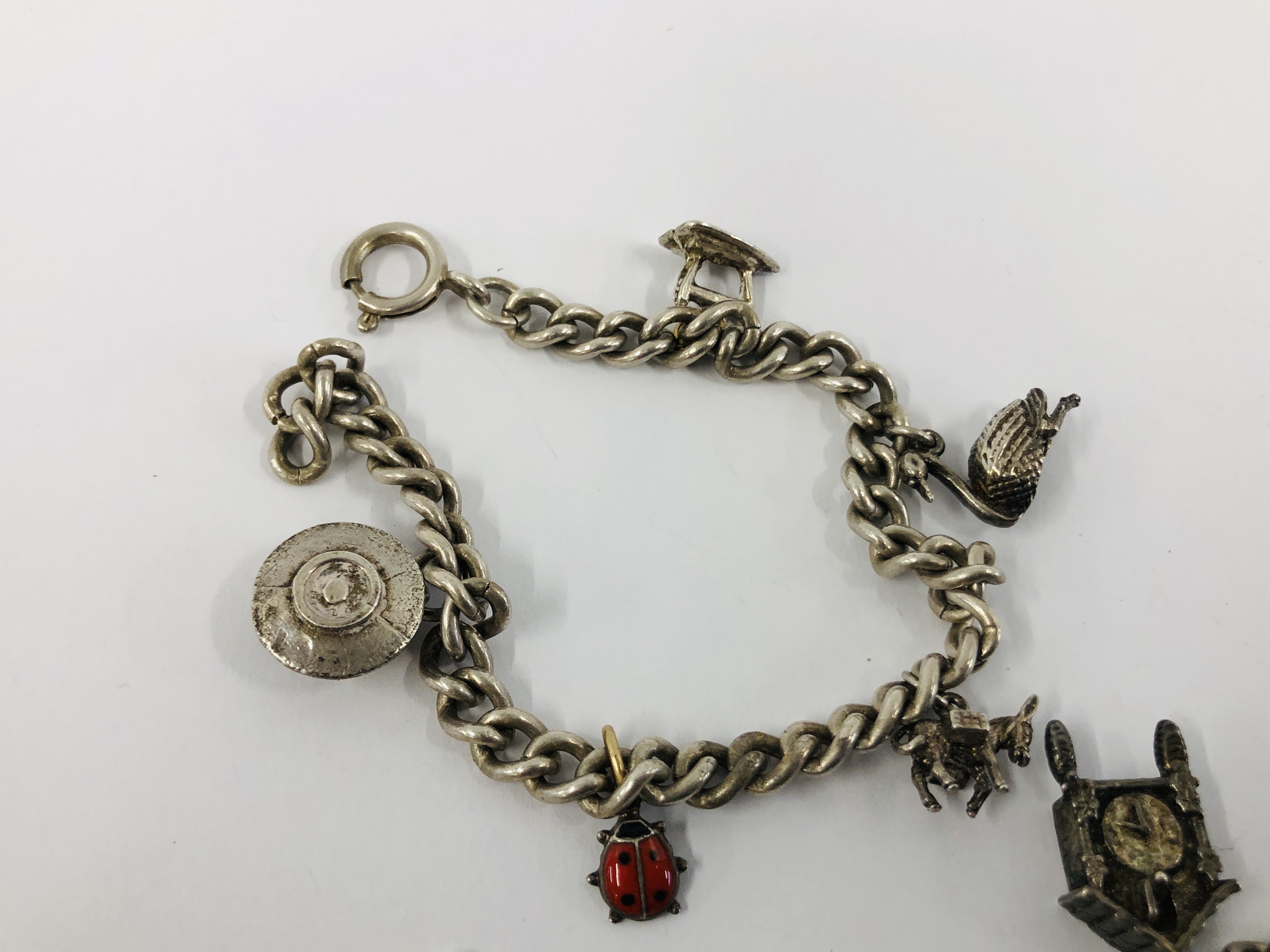 THREE VINTAGE SILVER CHARM BRACELETS TO INCLUDE VARIOUS SILVER AND WHITE METAL CHARMS. - Image 3 of 6