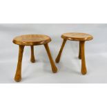 PAIR OF HONEY PINE LOW STOOLS ON TRIPOD LEGS BEARING IMPRESSED MAKERS MARK "INGVAR KAMPRAD"