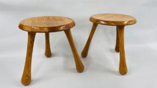 PAIR OF HONEY PINE LOW STOOLS ON TRIPOD LEGS BEARING IMPRESSED MAKERS MARK "INGVAR KAMPRAD"