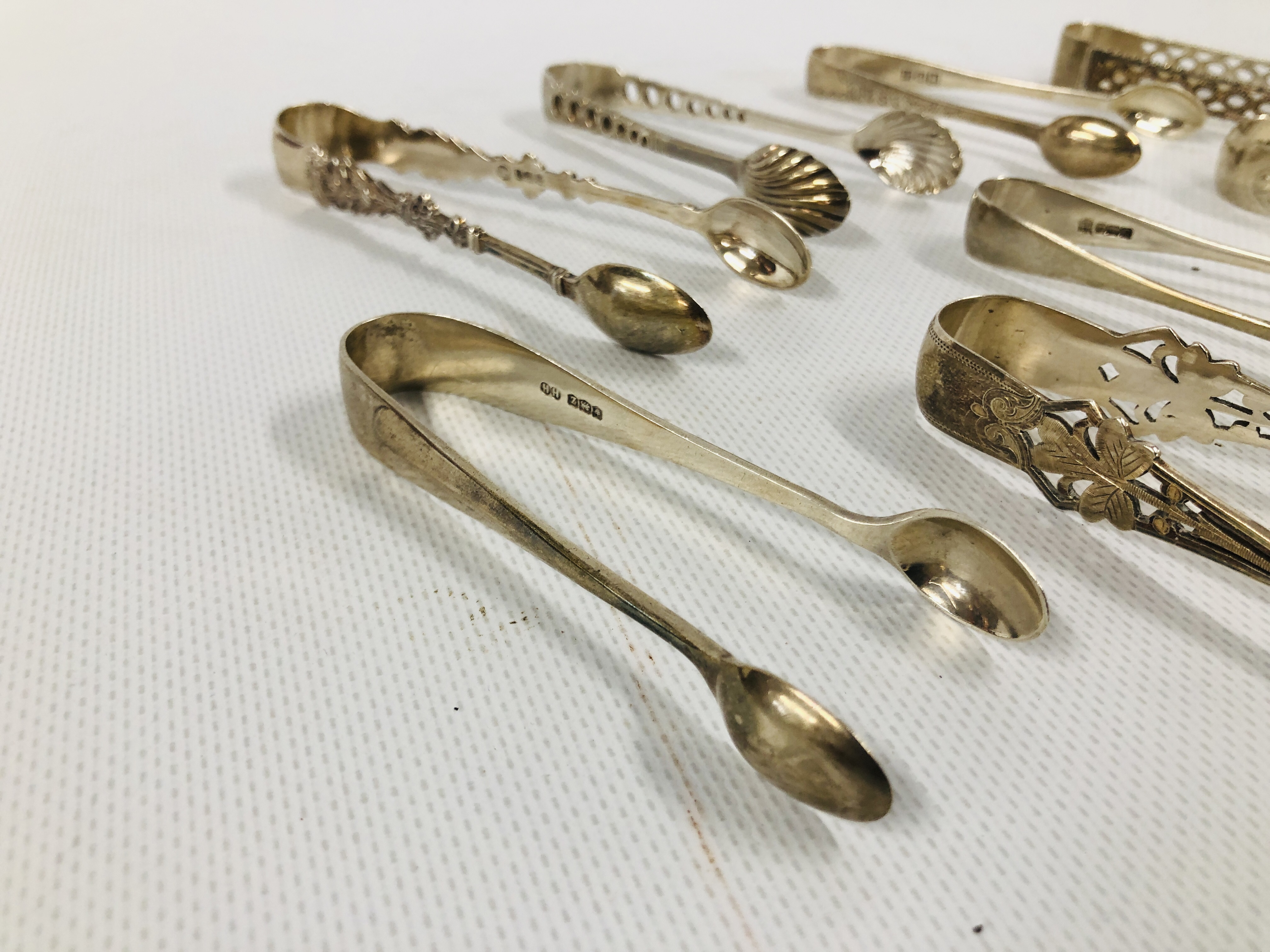 GROUP OF 8 VARIOUS SILVER SUGAR NIPS INCLUDING A PIERCED EXAMPLE, VARIOUS MAKERS AND ASSAYS. - Image 2 of 6