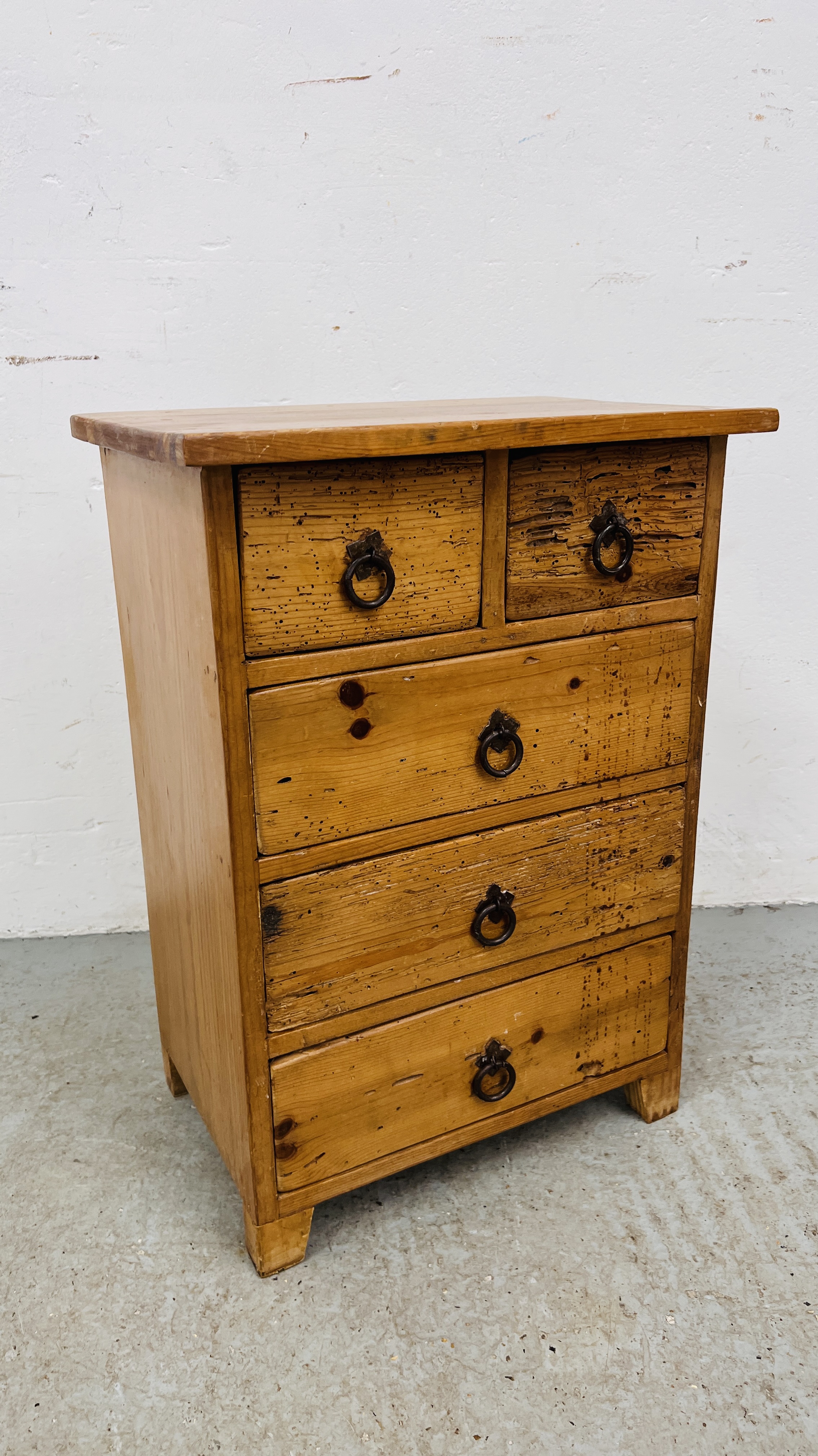 A RUSTIC PINE TWO OVER THREE DRAWER LOW CHEST HEIGHT 64CM. WIDTH 46CM. DEPTH 31CM.