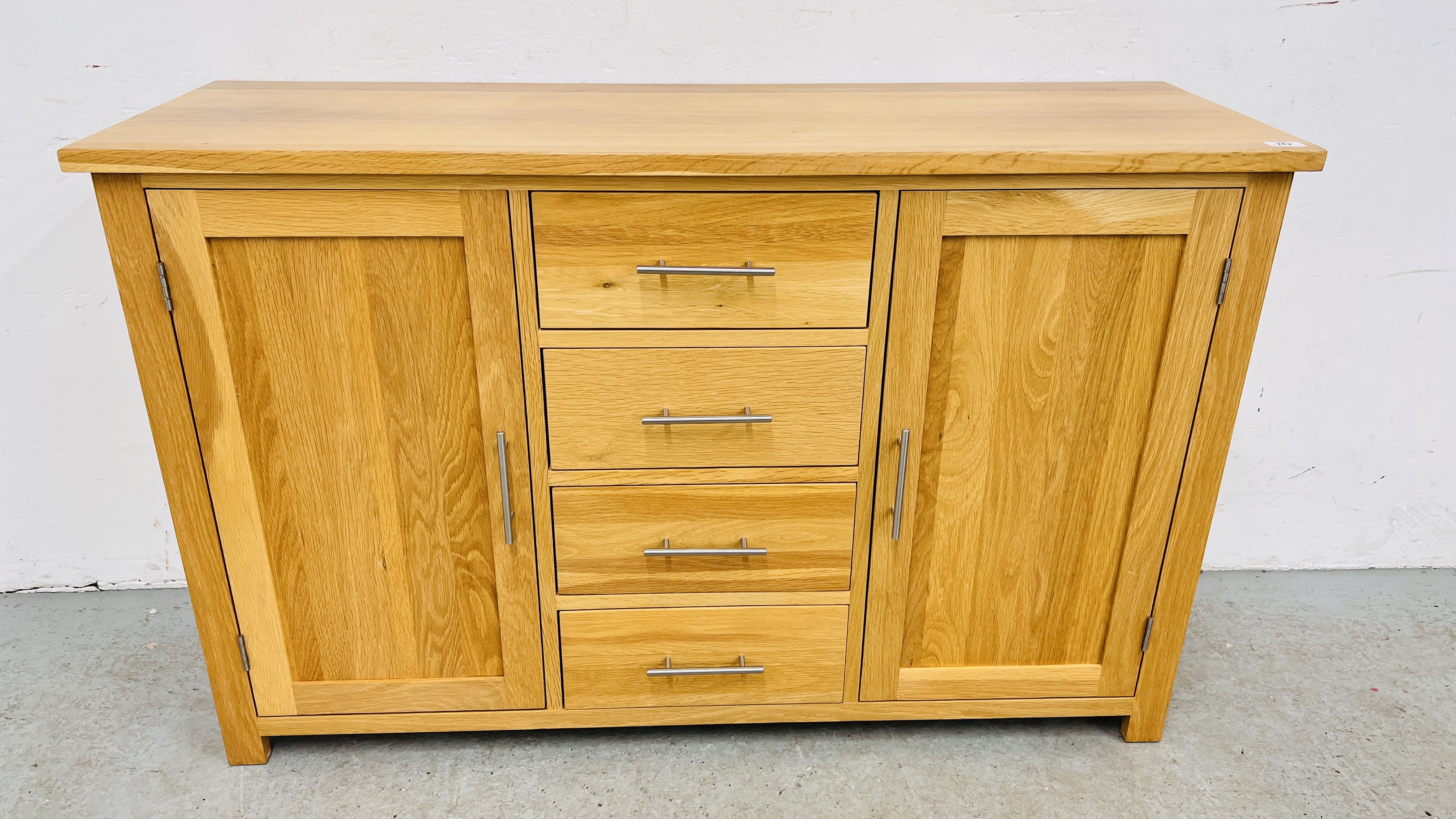 MODERN SOLID LIGHT OAK SIDEBOARD THREE CENTRAL DRAWERS FLANKED BY TWO CUPBOARD DOORS, W 131CM,