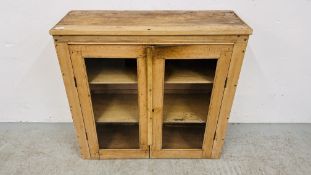 A VINTAGE WAXED PINE TWO DOOR GLAZED CABINET WIDTH 89CM. DEPTH 32CM. HEIGHT 86CM.