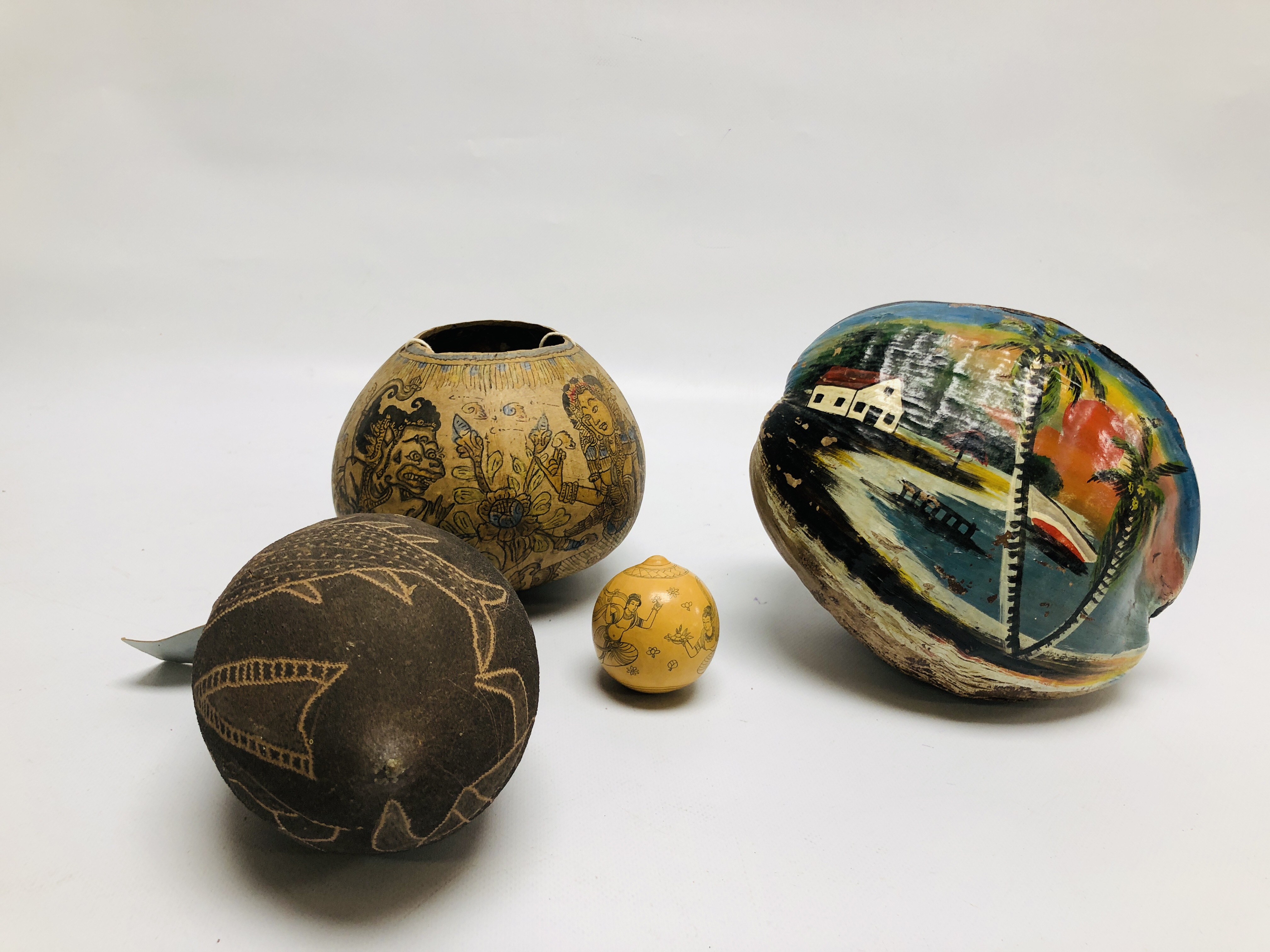 A NUT CARVED BY ABORIGINES DEPICTING SEA CREATURES A/F ALONG WITH A VESSEL MADE USING A NUT