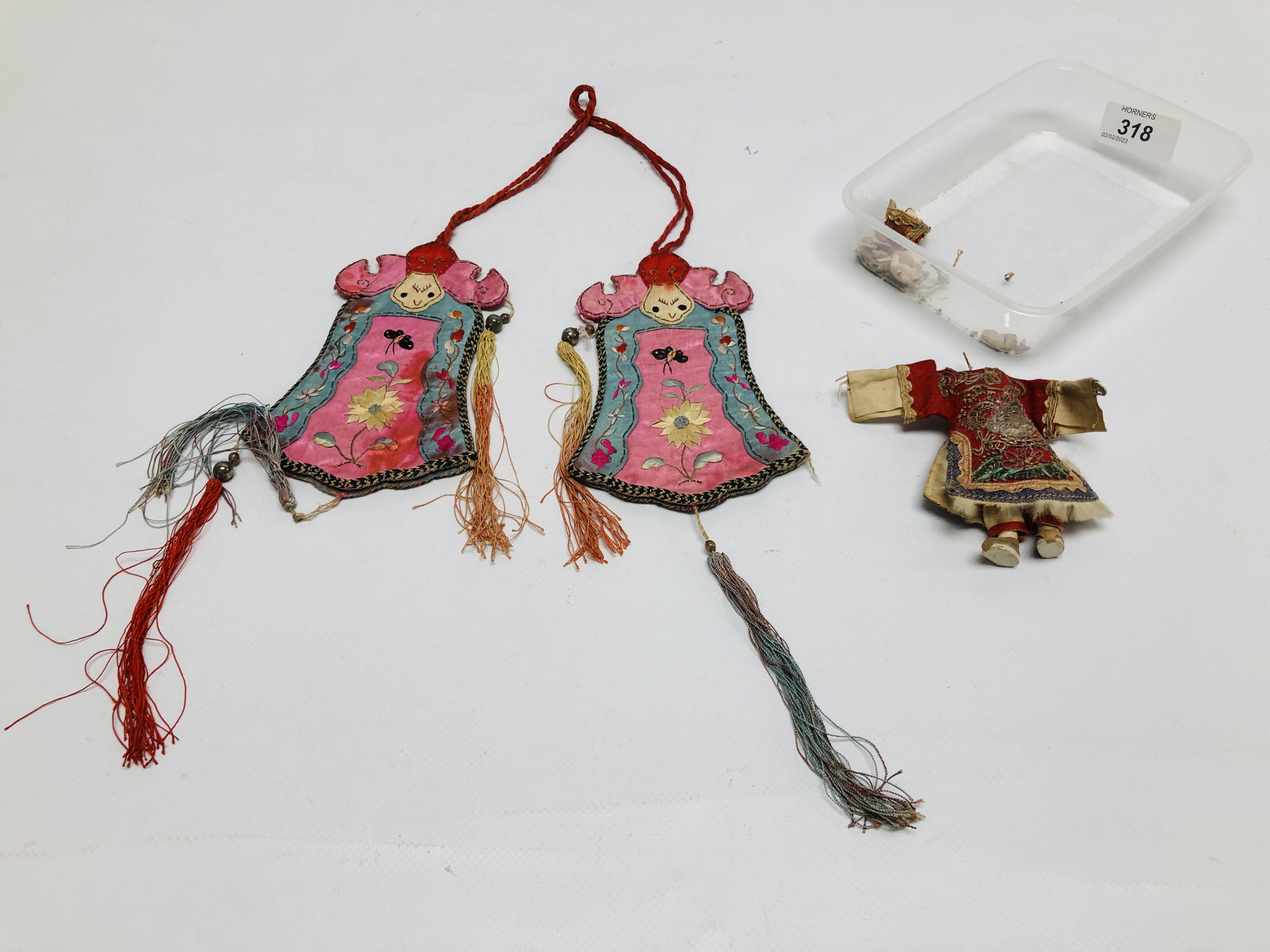 AN ORIENTAL VINTAGE SILK EMBRIODERED HANGING ALONG WITH A MINIATURE HANDMADE DOLL A/F