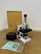 A BOXED BIOLOGICAL MICROSCOPE WITH ACCESSORIES.