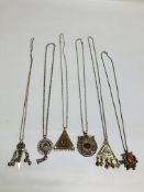 A GROUP OF 6 ASSORTED EASTERN STYLE WHITE METAL PENDANT NECKLACES TO INCLUDE STONE SET EXAMPLES.