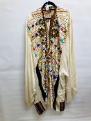 AN EGYPTIAN STYLE SILK KAFTAN SMOCK EMBROIDERED WITH AN ELABORATE APPLIED BUTTON WORK DESIGN